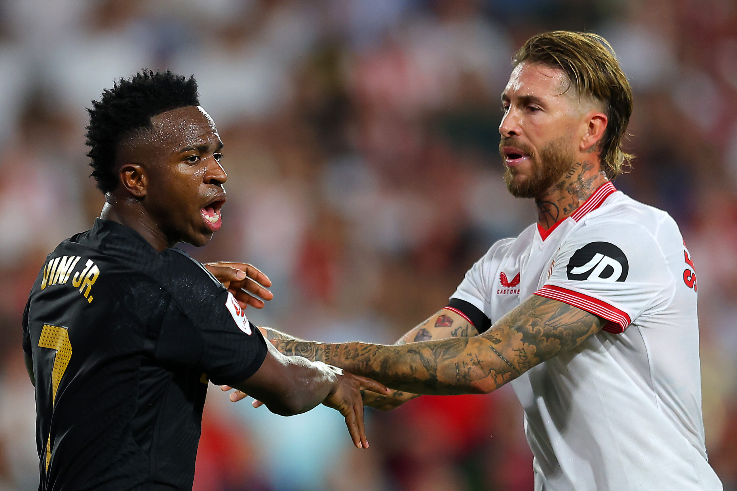 SEVILLE, SPAIN - OCTOBER 21: Vinicius Junior of Real Madrid and Sergio Ramos of Sevilla FC clash during the LaLiga EA Sports match between Sevilla FC and Real Madrid CF at Estadio Ramon Sanchez Pizjuan on October 21, 2023 in Seville, Spain.