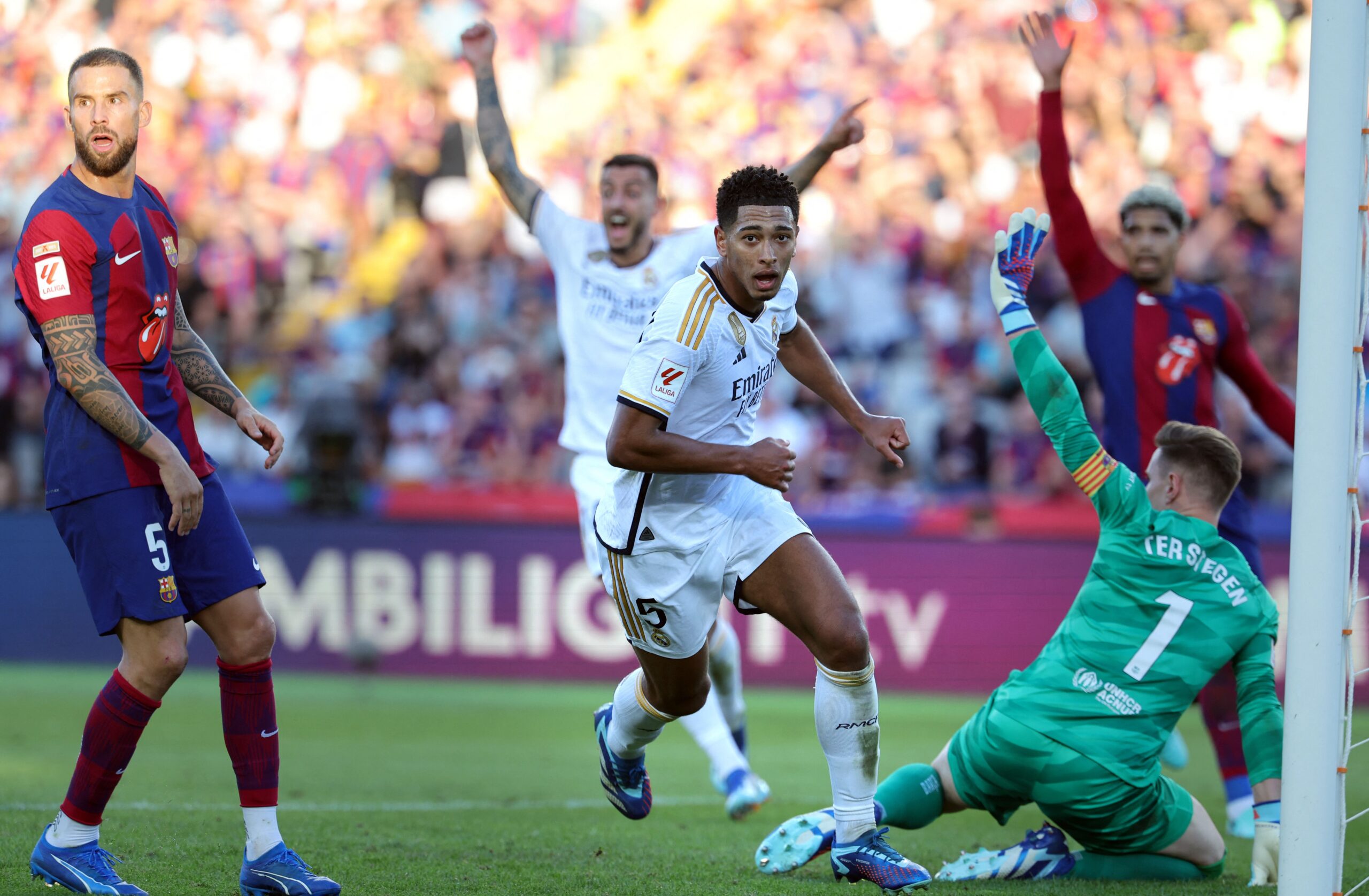 TOPSHOT - Real Madrid's English midfielder #5 Jude Bellingham (C) celebrates scoring his team's second goal during the Spanish league football match between FC Barcelona and Real Madrid CF at the Estadi Olimpic Lluis Companys in Barcelona on October 28, 2023.
