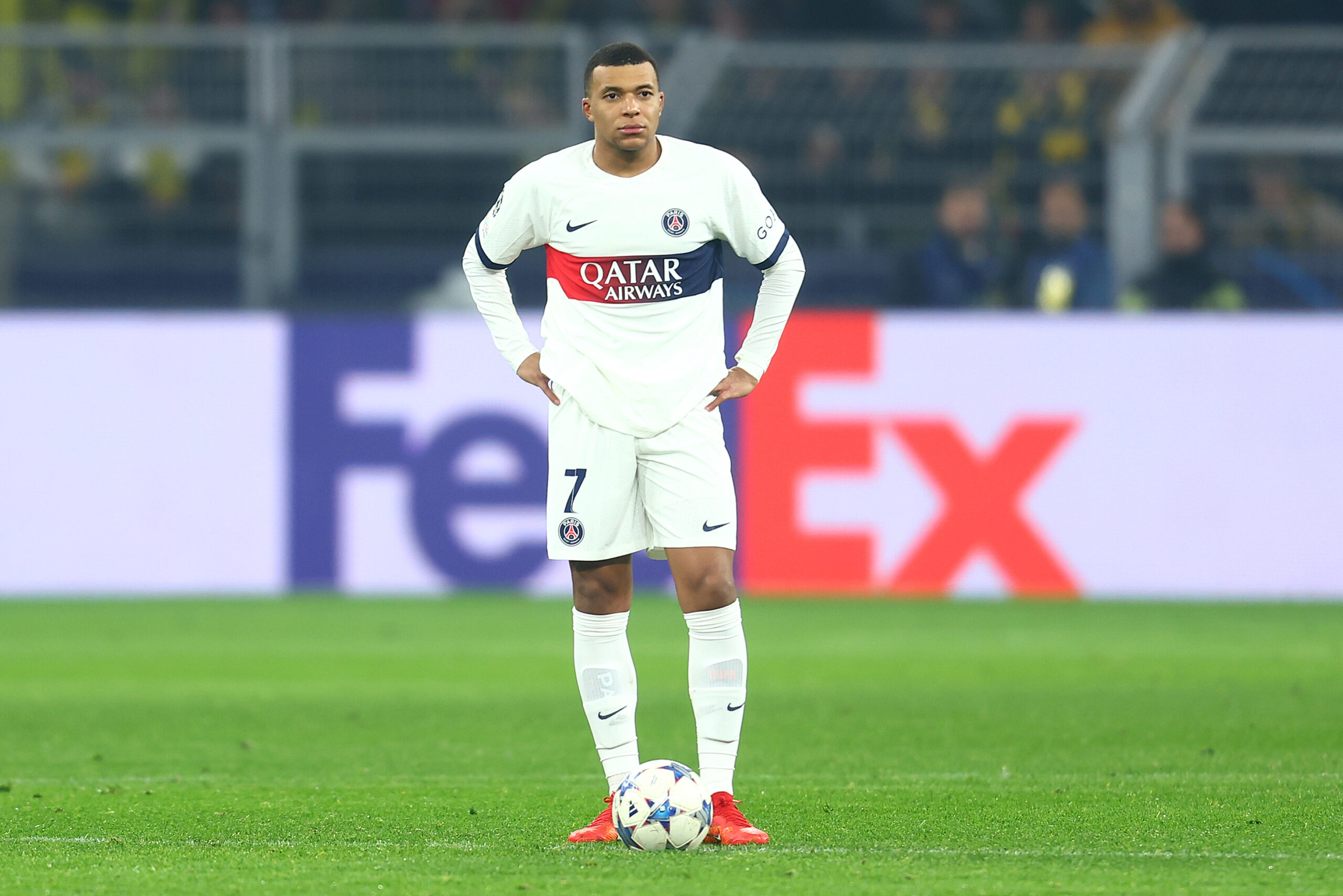 DORTMUND, GERMANY - DECEMBER 13: Kylian Mbappe of Paris Saint-Germain looks dejected after Karim Adeyemi of Borussia Dortmund scores their team's first goal during the UEFA Champions League match between Borussia Dortmund and Paris Saint-Germain at Signal Iduna Park on December 13, 2023 in Dortmund, Germany.