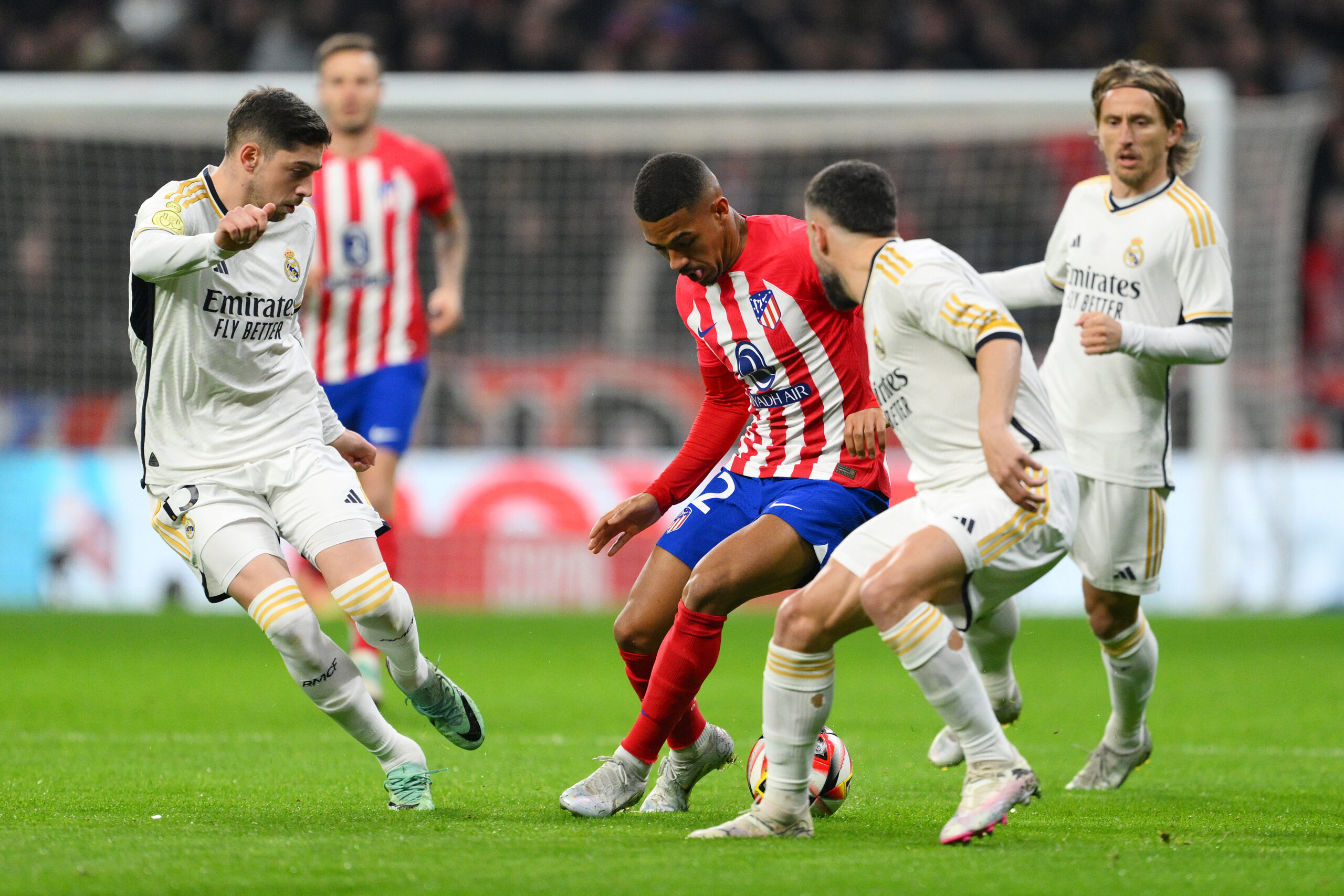 MADRID, SPAIN - JANUARY 18: Samuel Lino of Atletico Madrid is challenged by Federico Valverde, Daniel Carvajal and Luka Modric of Real Madrid during the Copa del Rey Round of 16 match between Atletico Madrid and Real Madrid CF at Civitas Metropolitano Stadium on January 18, 2024 in Madrid, Spain.