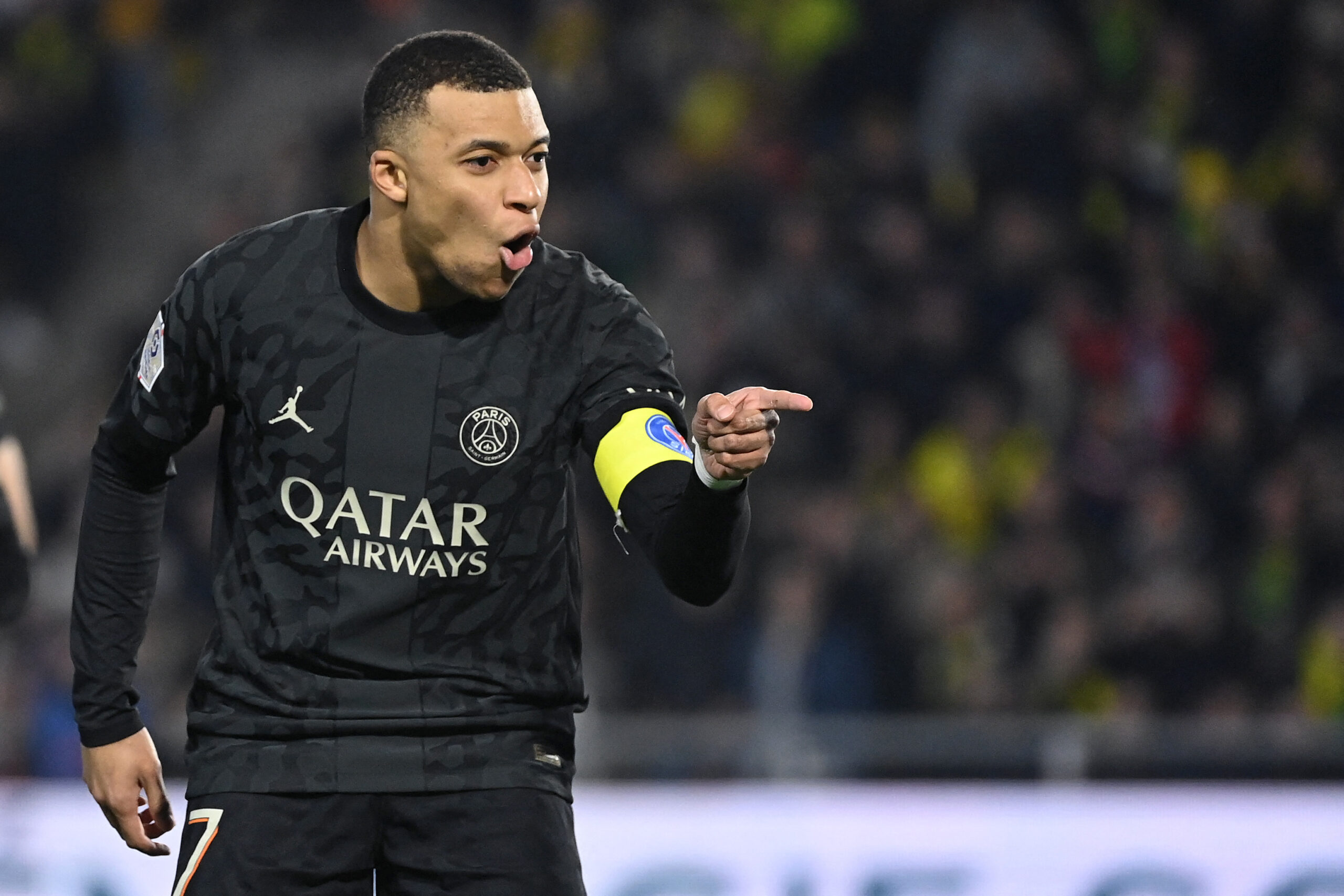 TOPSHOT - Paris Saint-Germain's French forward #07 Kylian Mbappe reacts after scoring his team's second goal during the French L1 football match between FC Nantes and Paris Saint-Germain (PSG) at the La Beaujoire stadium in Nantes, western France, on February 17, 2024.