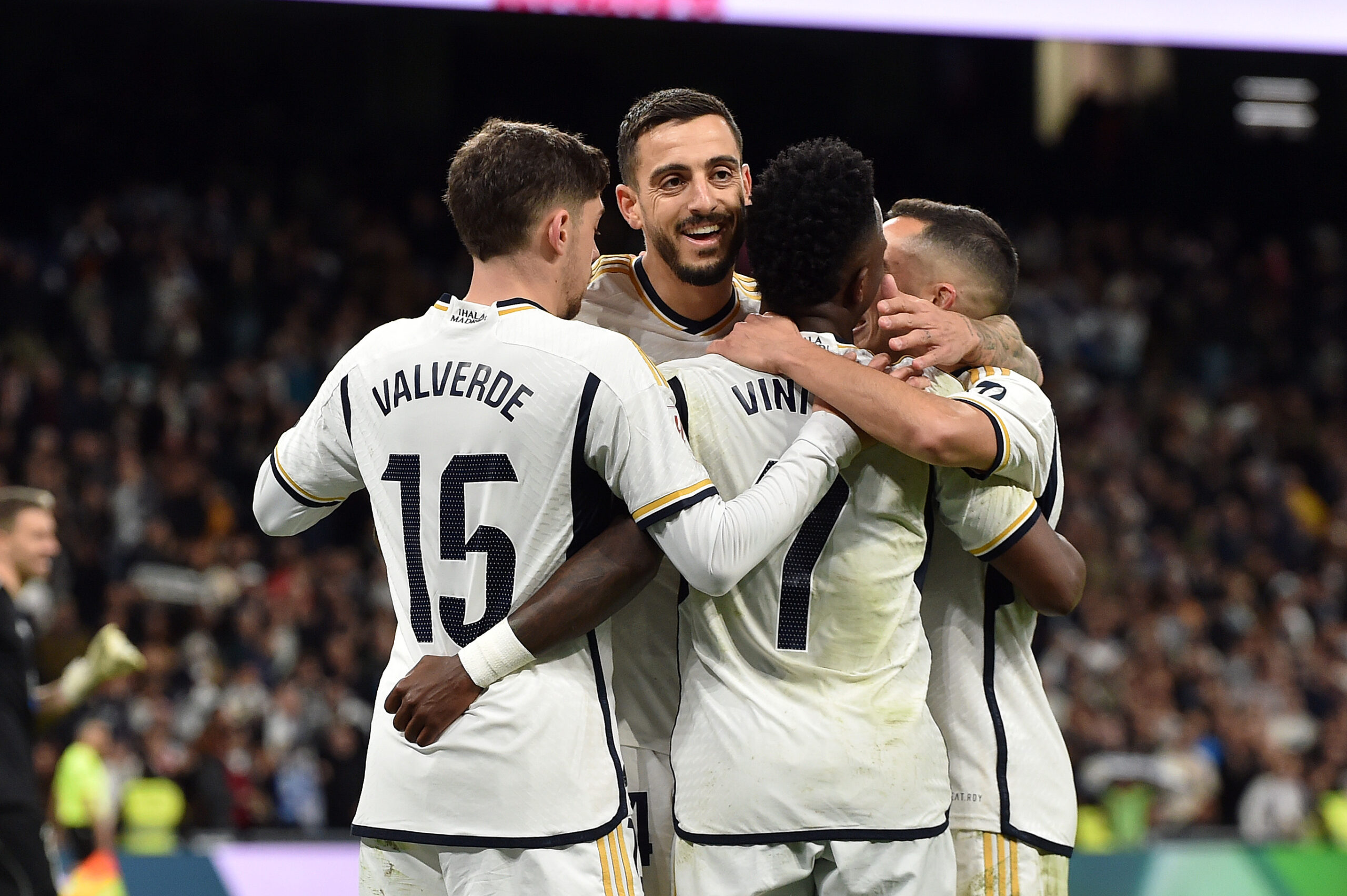 MADRID, SPAIN - MARCH 10: Federico Valverde, Joselu and Vinicius Junior of Real Madrid celebrate after Carlos Dominguez of Celta Vigo (not pictured) scores an own-goal, and a third goal for Real Madrid, during the LaLiga EA Sports match between Real Madrid CF and Celta Vigo at Estadio Santiago Bernabeu on March 10, 2024 in Madrid, Spain.