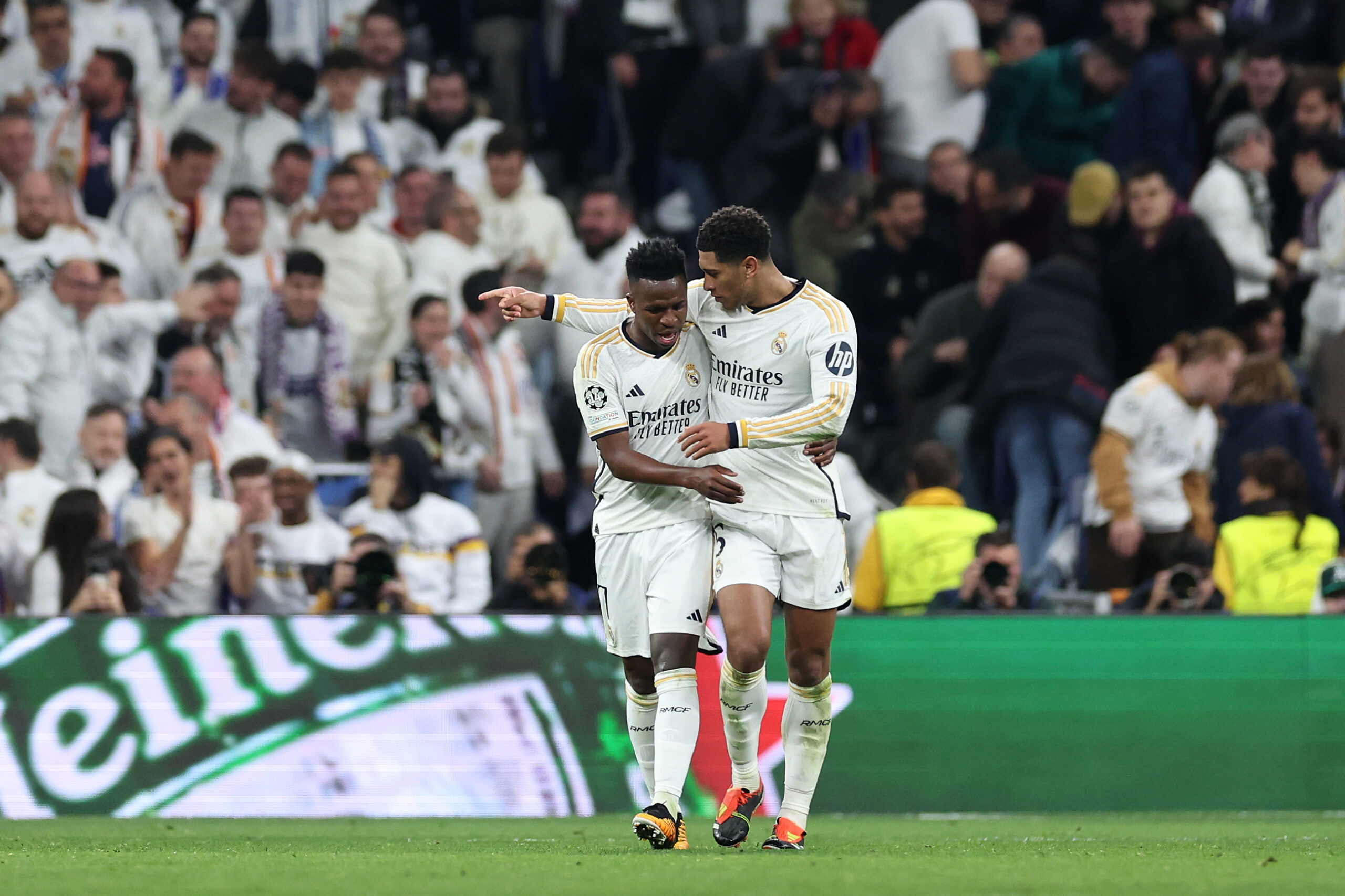 MADRID, SPAIN - MARCH 06: Vinicius Junior (L) of Real Madrid CF celebrates scoring their opening goal with teammate Jude Bellingham (R) during the UEFA Champions League 2023/24 round of 16 second leg match between Real Madrid CF and RB Leipzig at Estadio Santiago Bernabeu on March 06, 2024 in Madrid, Spain.