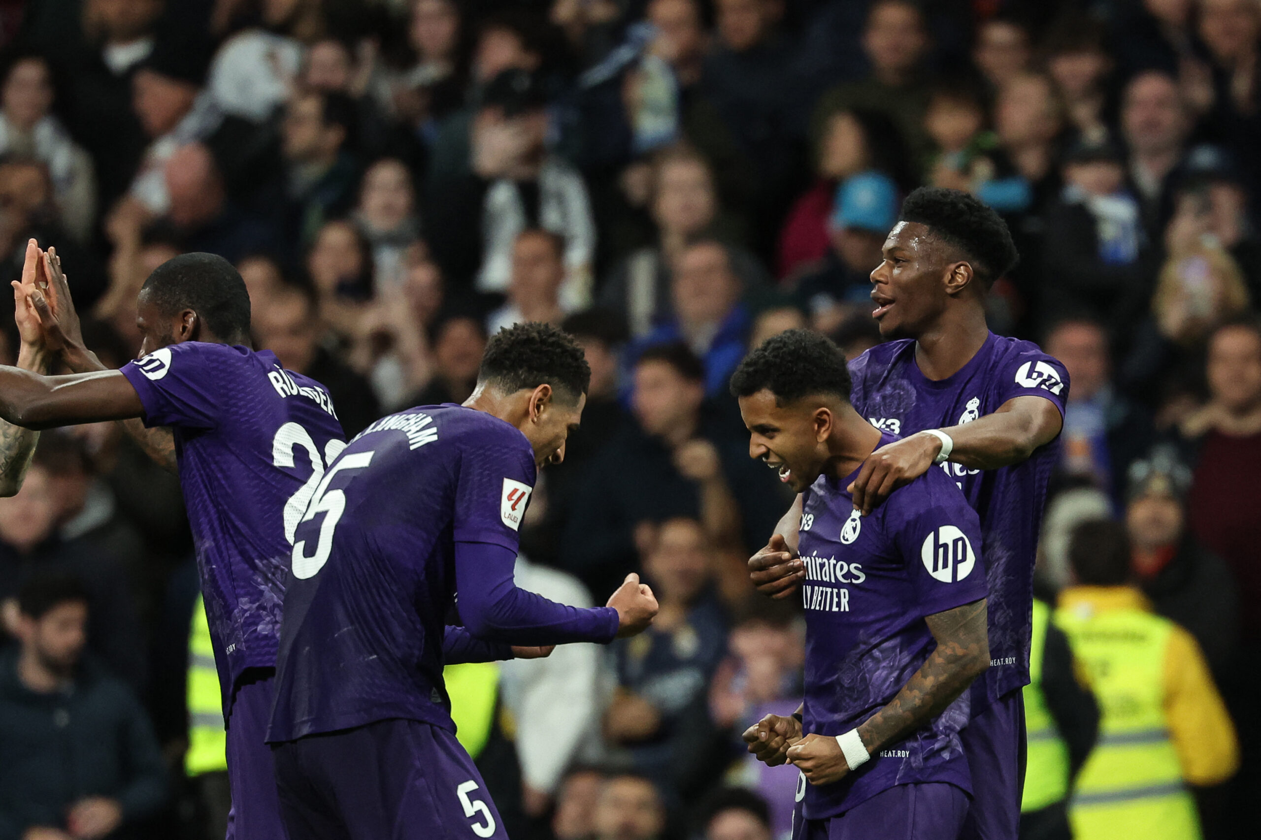 CORRECTION / Real Madrid's Brazilian forward #11 Rodrygo (2nd-R) celebrates with teammates after scoring his team's second goal during the Spanish league football match between Real Madrid CF and Athletic Club Bilbao at the Santiago Bernabeu stadium in Madrid on March 31, 2024.