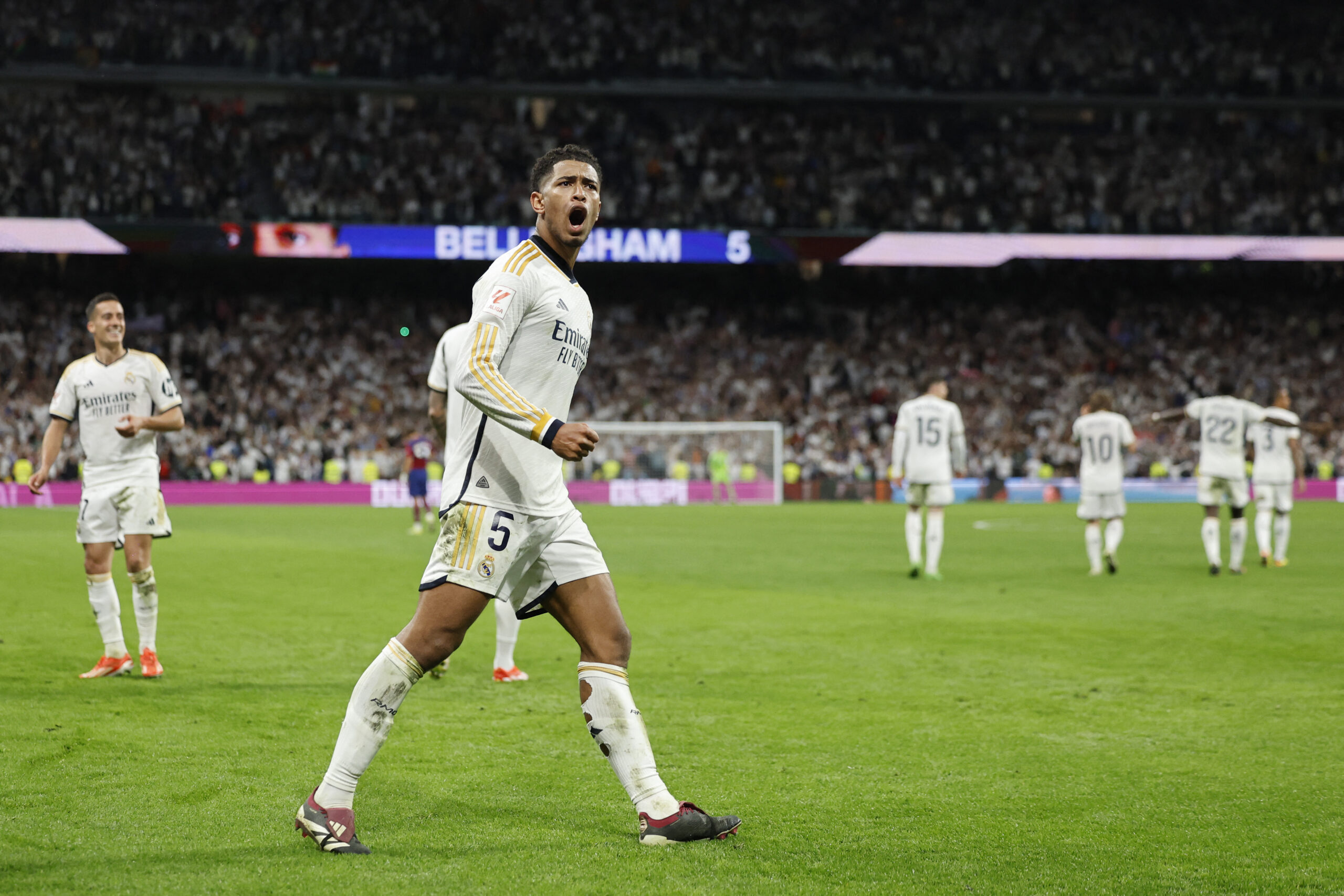 Real Madrid's English midfielder #5 Jude Bellingham celebrates scoring his team's third goal during the Spanish league football match between Real Madrid CF and FC Barcelona at the Santiago Bernabeu stadium in Madrid on April 21, 2024.