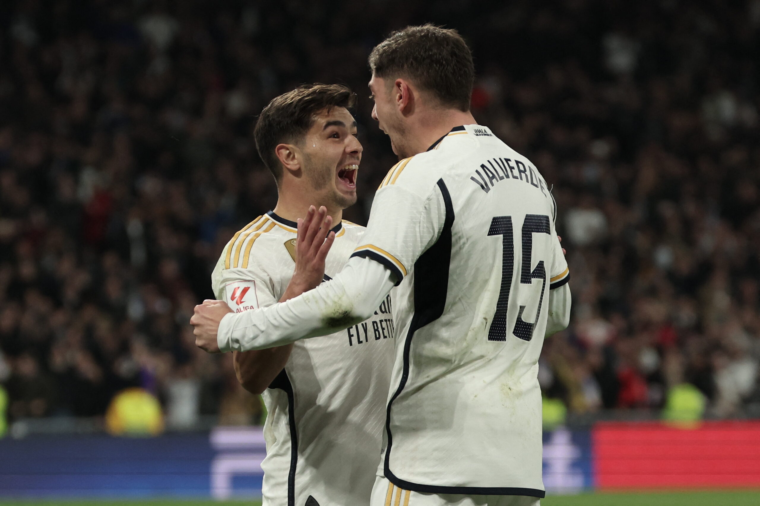 Real Madrid's Spanish forward #21 Brahim Diaz celebrates with Real Madrid's Uruguayan midfielder #15 Federico Valverde after scoring his team's third goal during the Spanish league football match between Real Madrid CF and Villarreal CF at the Santiago Bernabeu stadium in Madrid on December 17, 2023.