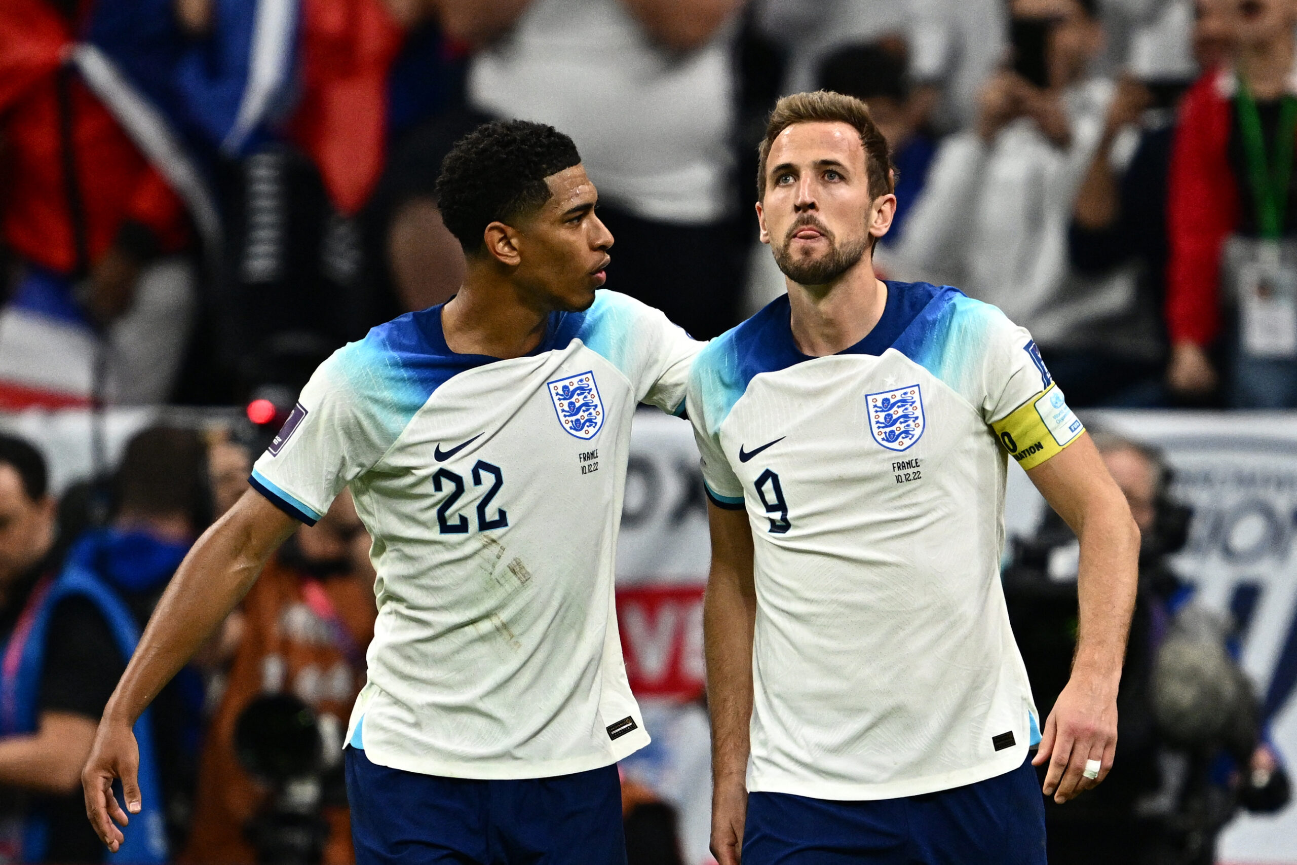England's forward #09 Harry Kane (R) is comforted by England's midfielder #22 Jude Bellingham after he missed a penalty kick during the Qatar 2022 World Cup quarter-final football match between England and France at the Al-Bayt Stadium in Al Khor, north of Doha, on December 10, 2022.