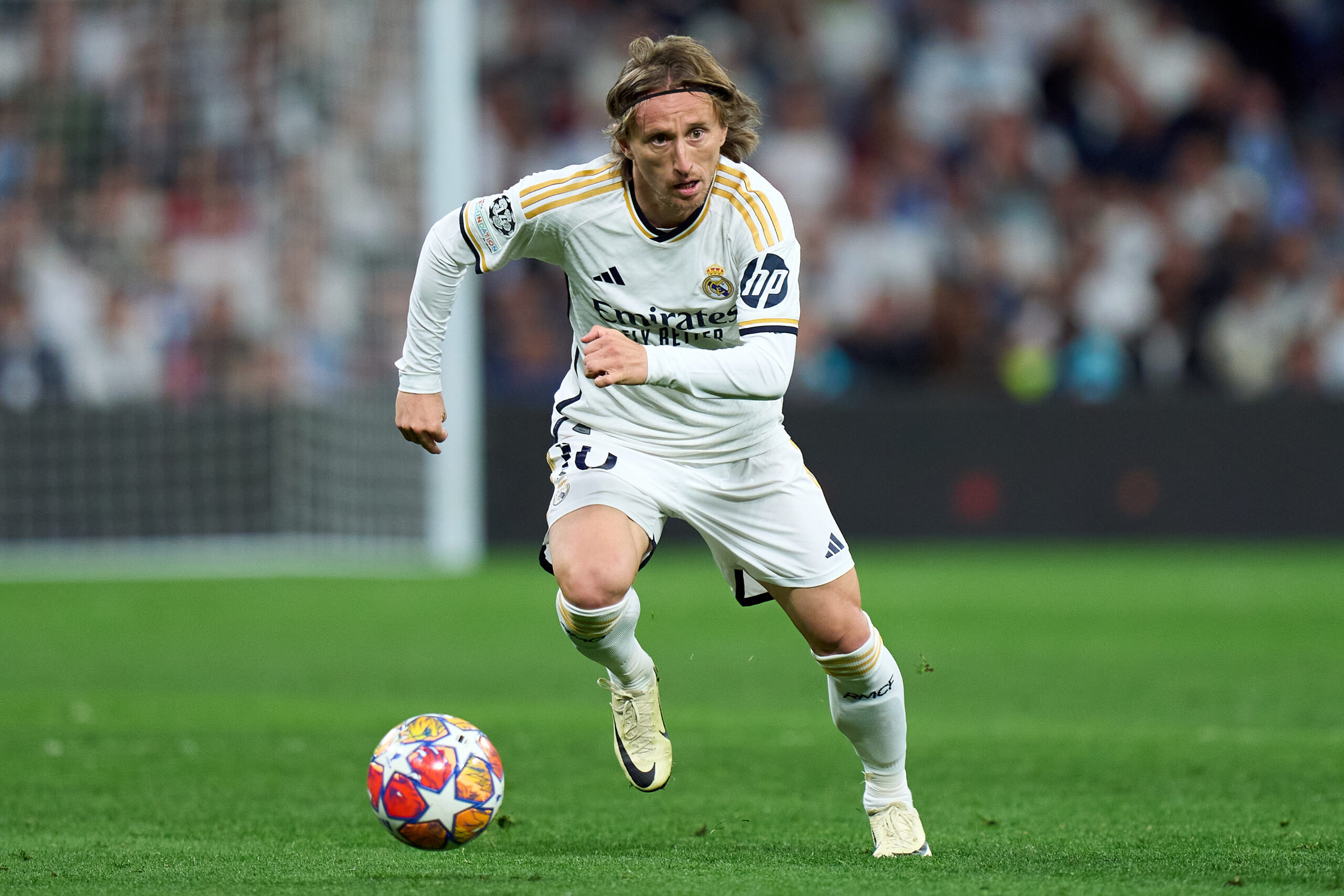 MADRID, SPAIN - APRIL 09: Luka Modric of Real Madrid runs with the ball during the UEFA Champions League quarter-final first leg match between Real Madrid CF and Manchester City at Estadio Santiago Bernabeu on April 09, 2024 in Madrid, Spain.
