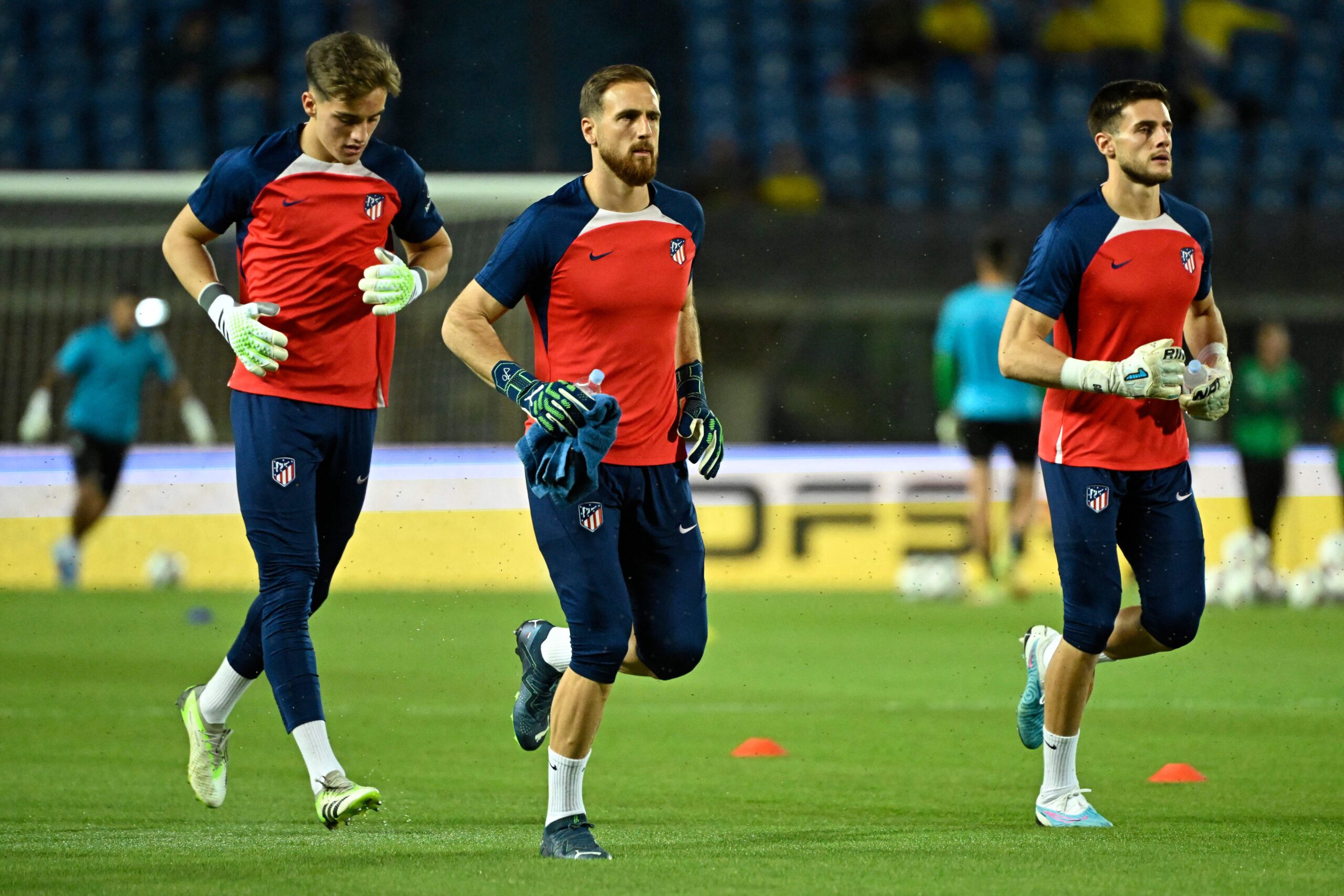 Atletico Madrid's Spanish goalkeeper #31 Antonio Gomis (R), Atletico Madrid's Slovenian goalkeeper #13 Jan Oblak (C) and Atletico Madrid's Spanish goalkeeper #35 Sergio Mestre warm up before the Spanish league football match between UD Las Palmas and Club Atletico de Madrid at the Gran Canaria stadium in Las Palmas de Gran Canaria on November 3, 2023.