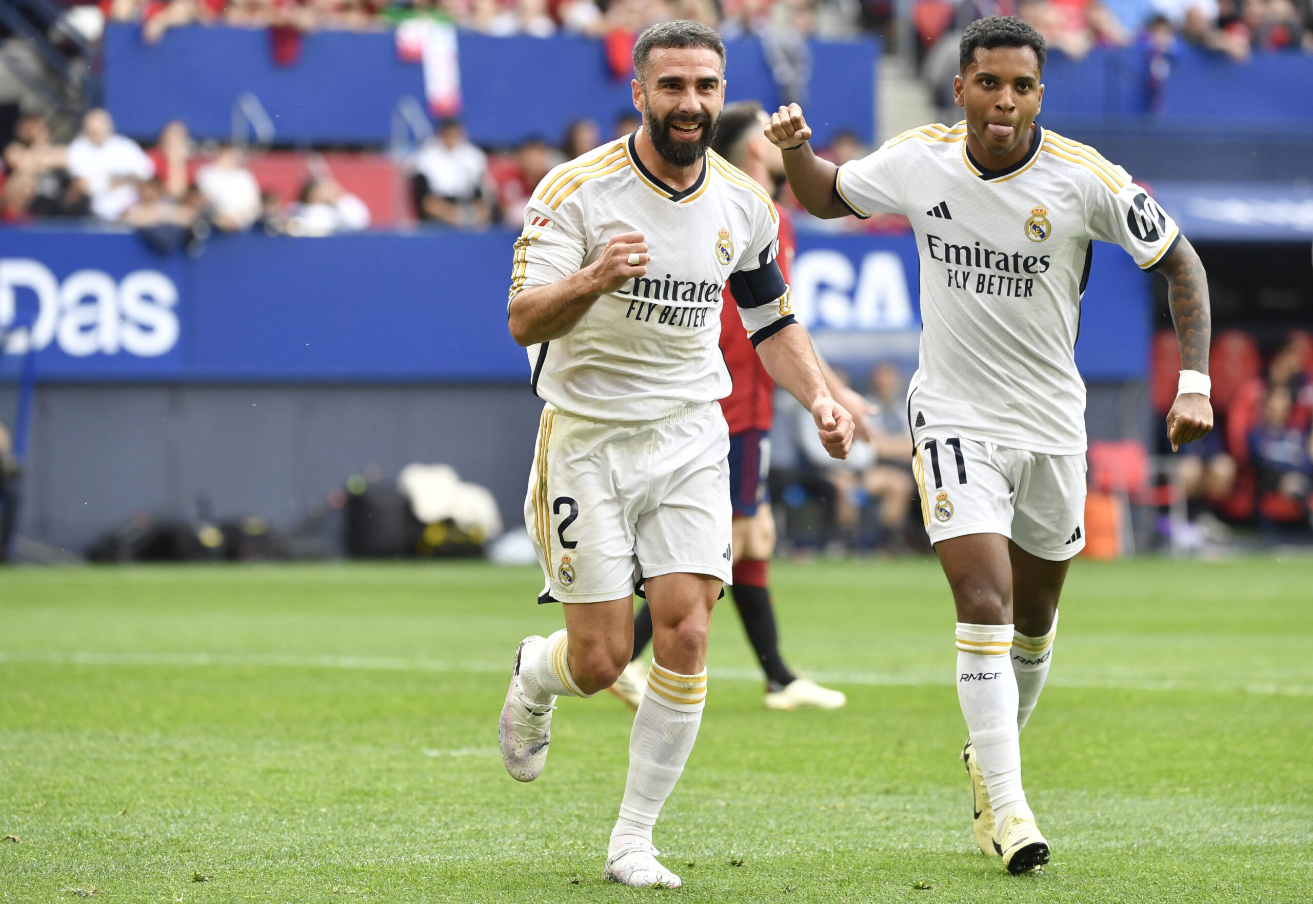 Real Madrid's Spanish defender #02 Dani Carvajal celebrates scoring his team's second goal, with Real Madrid's Brazilian forward #11 Rodrygo, during the Spanish league football match between CA Osasuna and Real Madrid CF at El Sadar stadium in Pamplona on March 16, 2024.