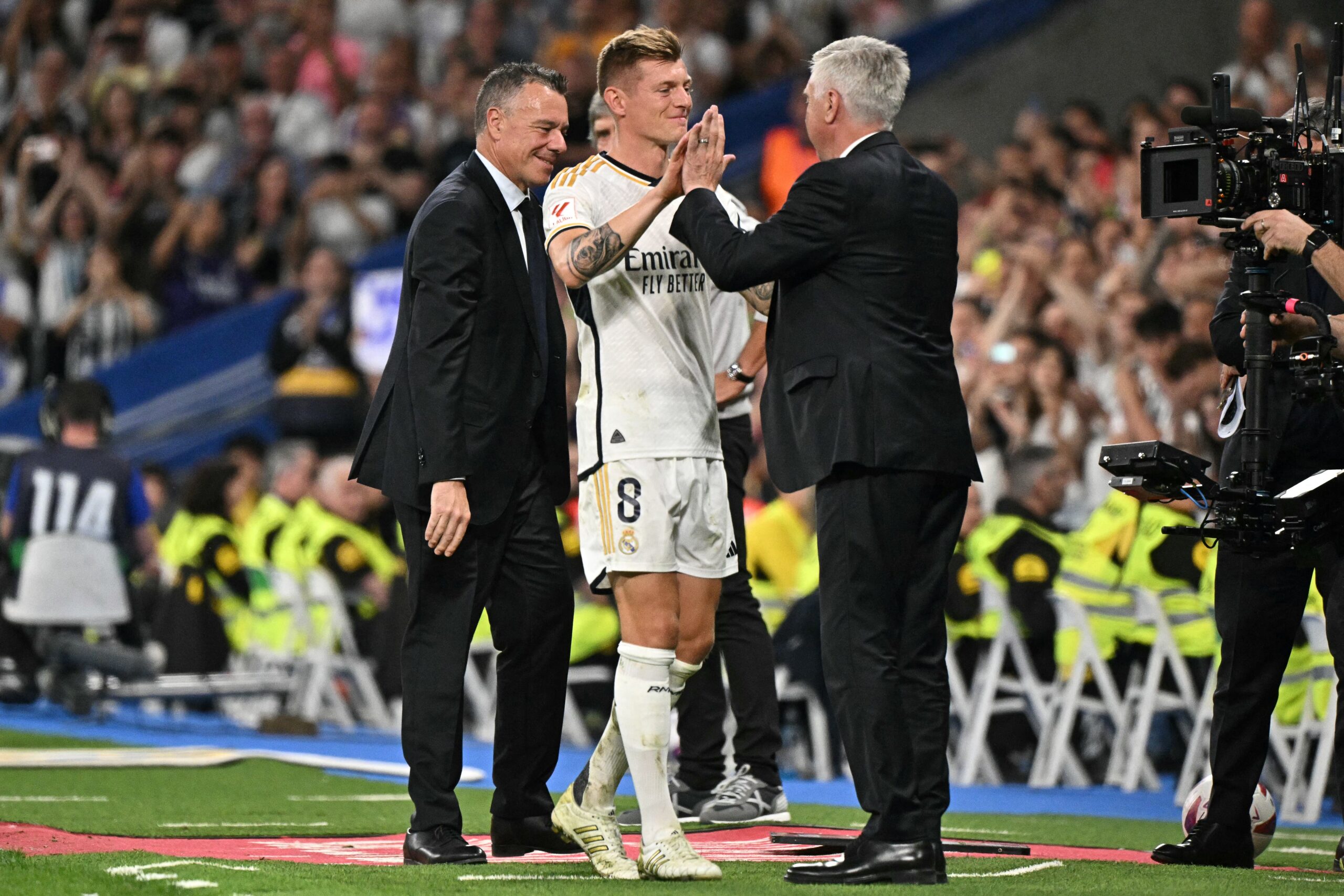 Real Madrid's German midfielder #08 Toni Kroos greets Real Madrid's Italian coach Carlo Ancelotti as he leaves the pitch during the Spanish league football match between Real Madrid CF and Real Betis at the Santiago Bernabeu stadium in Madrid on May 25, 2024. Real Madrid's German international midfielder Toni Kroos announced he will retire from all football after Euro 2024. Before the European Championship, Kroos has a chance to win the Champions League with Real for a fifth time when they face Borussia Dortmund at Wembley on June 1.