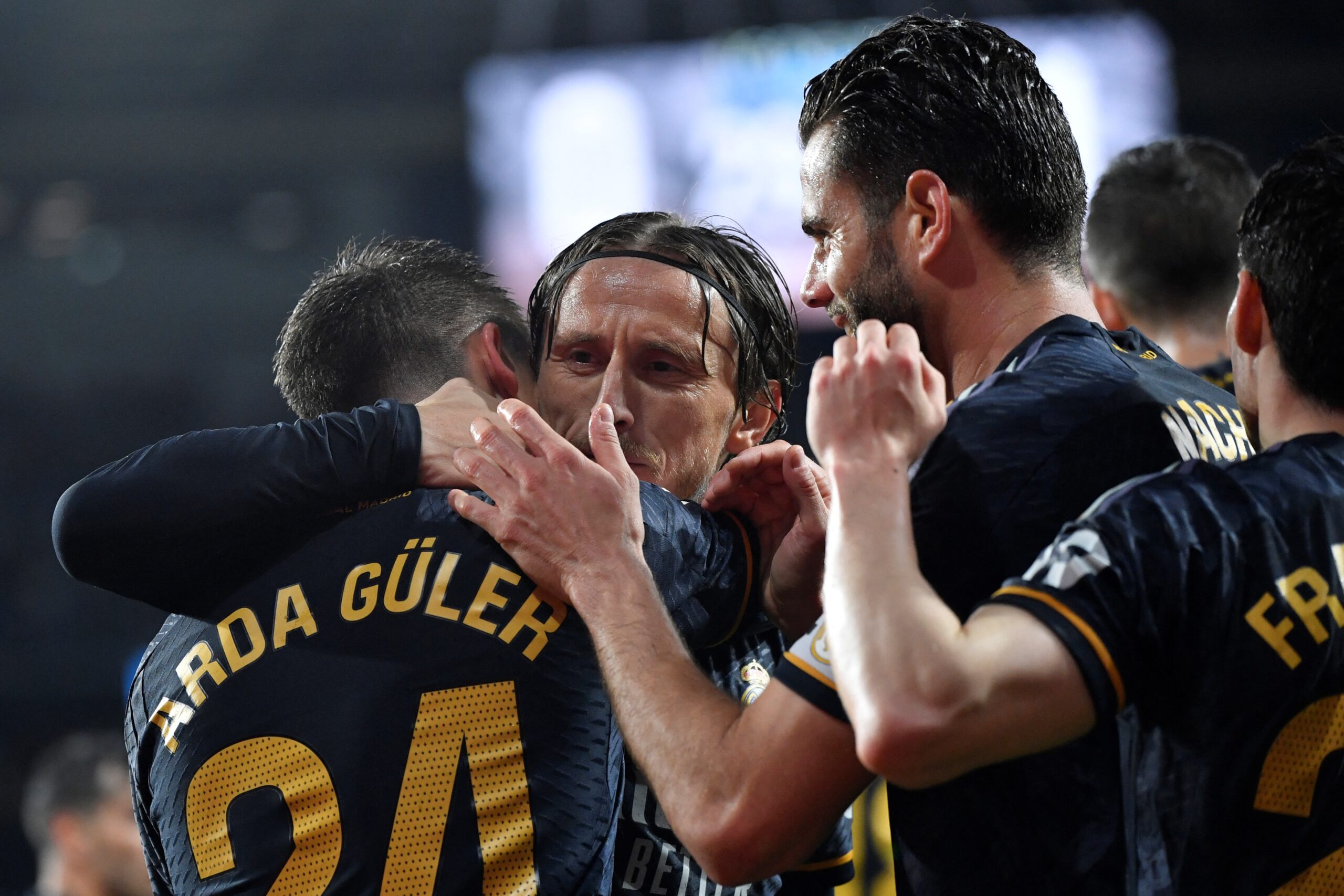 Real Madrid's Turkish midfielder #24 Arda Guler (L) celebrates with Real Madrid's Croatian midfielder #10 Luka Modric and teammates scoring his team's first goal during the Spanish league football match between Real Sociedad and Real Real Madrid CF at the Anoeta stadium in San Sebastian on April 26, 2024.