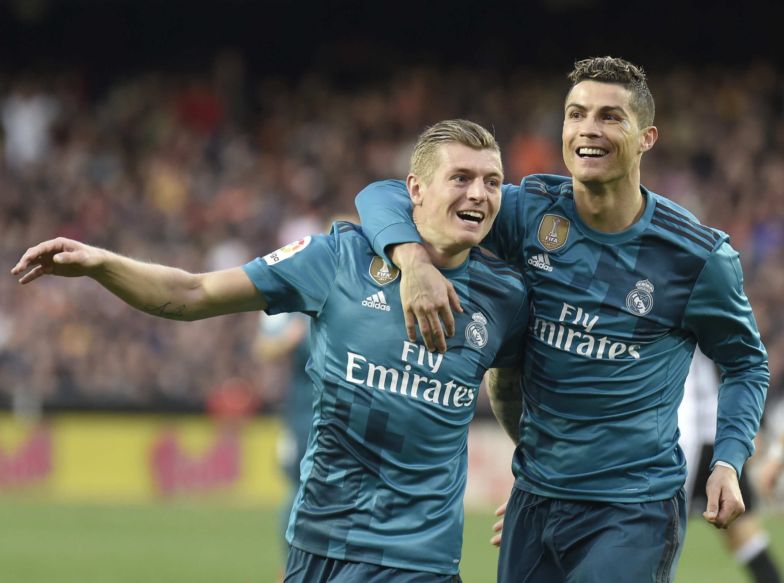 Real Madrid's German midfielder Toni Kroos (L) celebrates a goal with Real Madrid's Portuguese forward Cristiano Ronaldo during the Spanish league football match between Valencia CF and Real Madrid CF at the Mestalla stadium in Valencia on January 27,