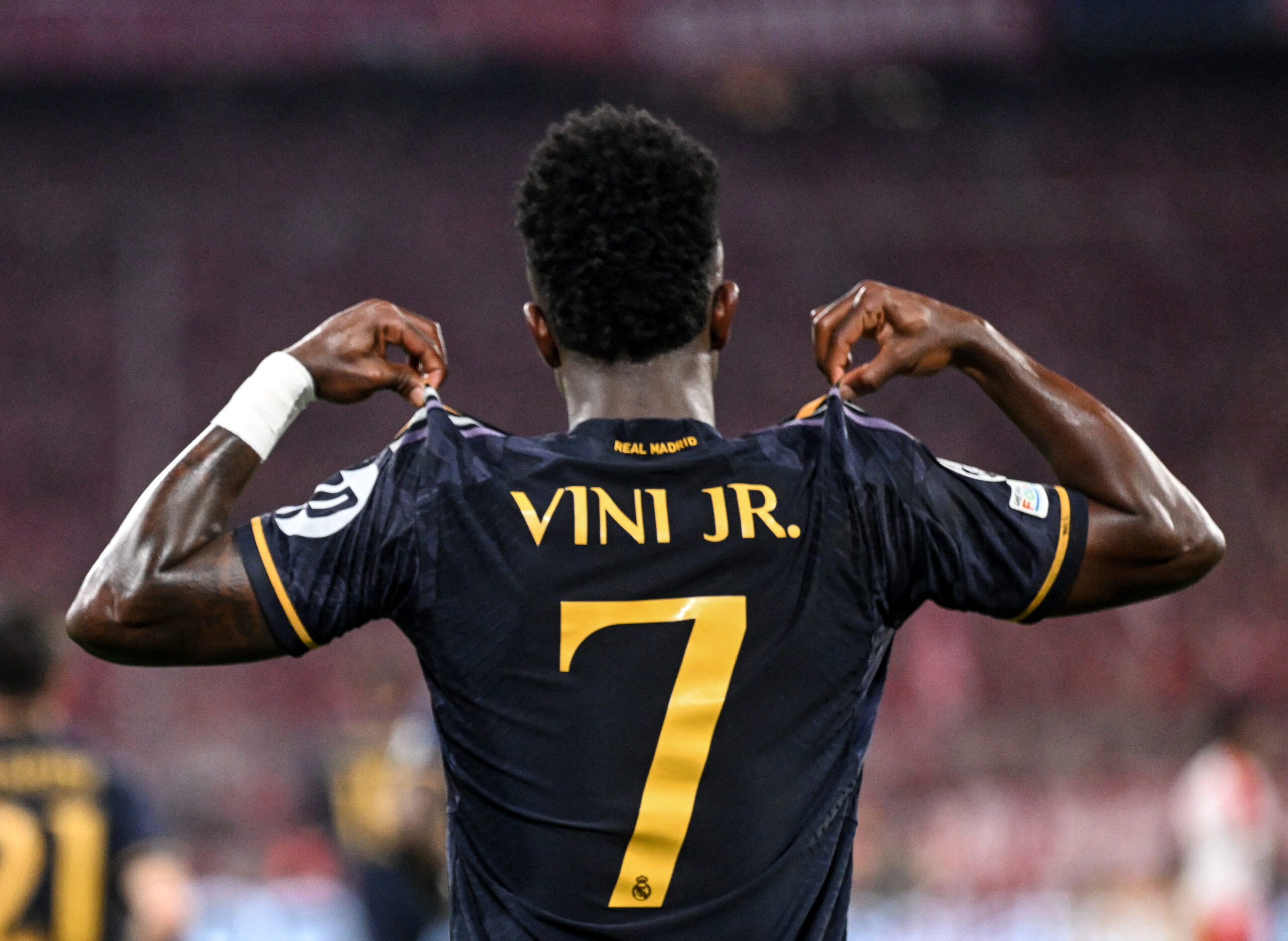 Real Madrid's Brazilian forward #07 Vinicius Junior celebrates scoring a penalty during the UEFA Champions League semi-final first leg football match between FC Bayern Munich and Real Madrid CF on April 30, 2024 in Munich, southern Germany.