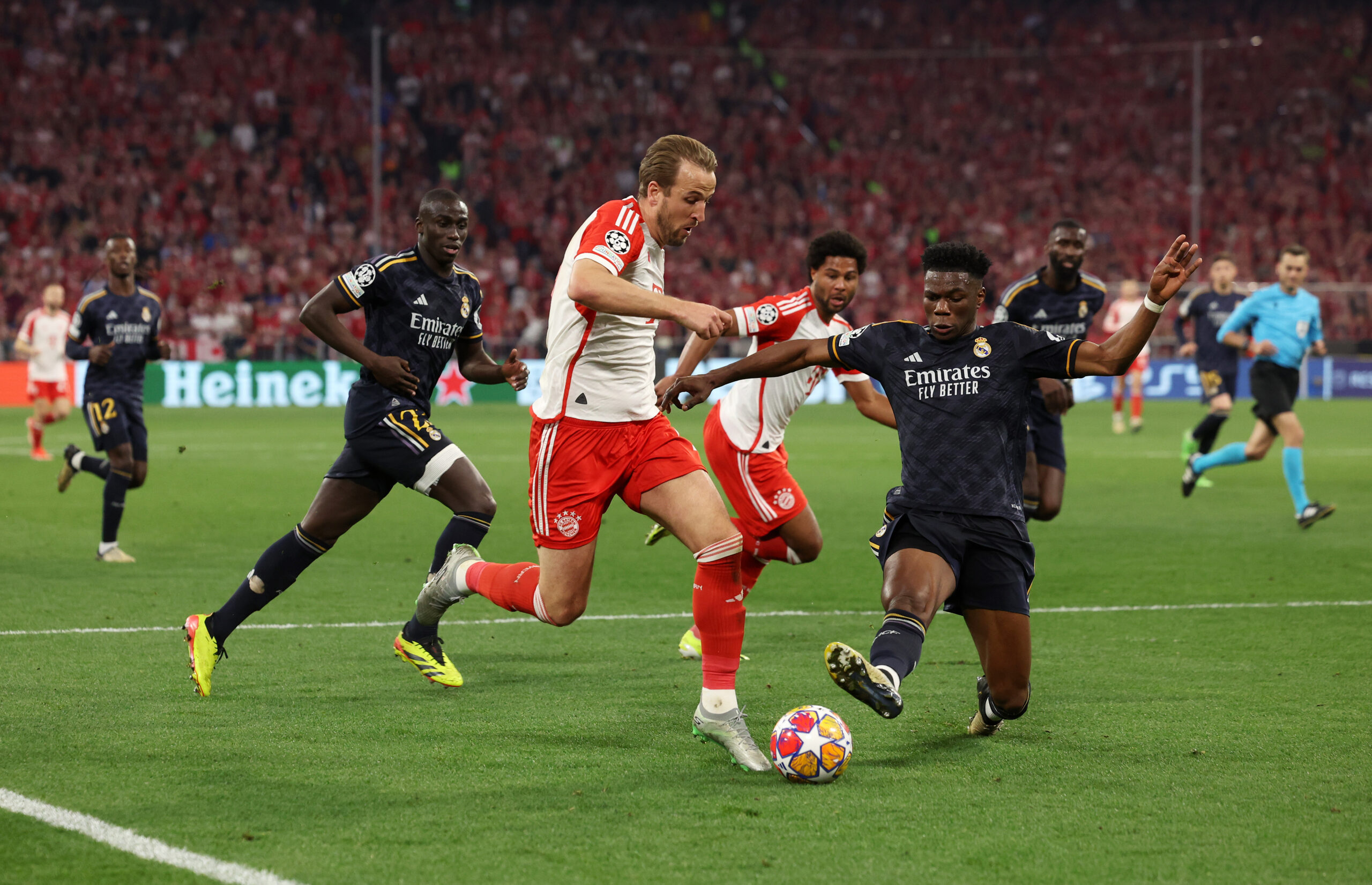 MUNICH, GERMANY - APRIL 30: Harry Kane of Bayern Munich is challenged by Aurelien Tchouameni of Real Madrid during the UEFA Champions League semi-final first leg match between FC Bayern München and Real Madrid at Allianz Arena on April 30, 2024 in Munich, Germany.