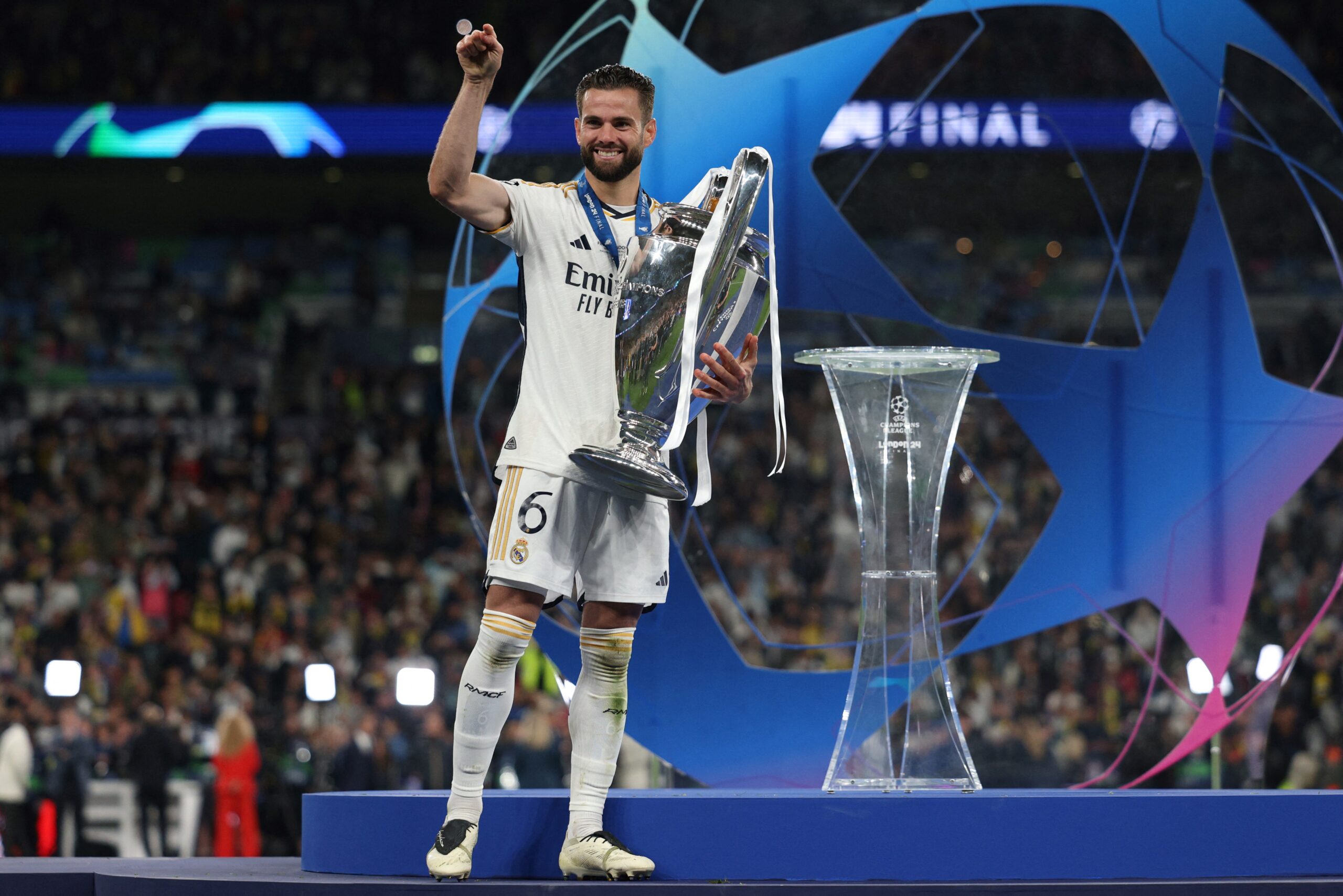 Real Madrid's Spanish defender #06 Nacho Fernandez holds the trophy in order to celebrate with his teammates after winning the UEFA Champions League final football match between Borussia Dortmund and Real Madrid, at Wembley stadium, in London, on June 1, 2024. Real Madrid wins the Champions League final 2 - 0 against Borussia Dortmund.