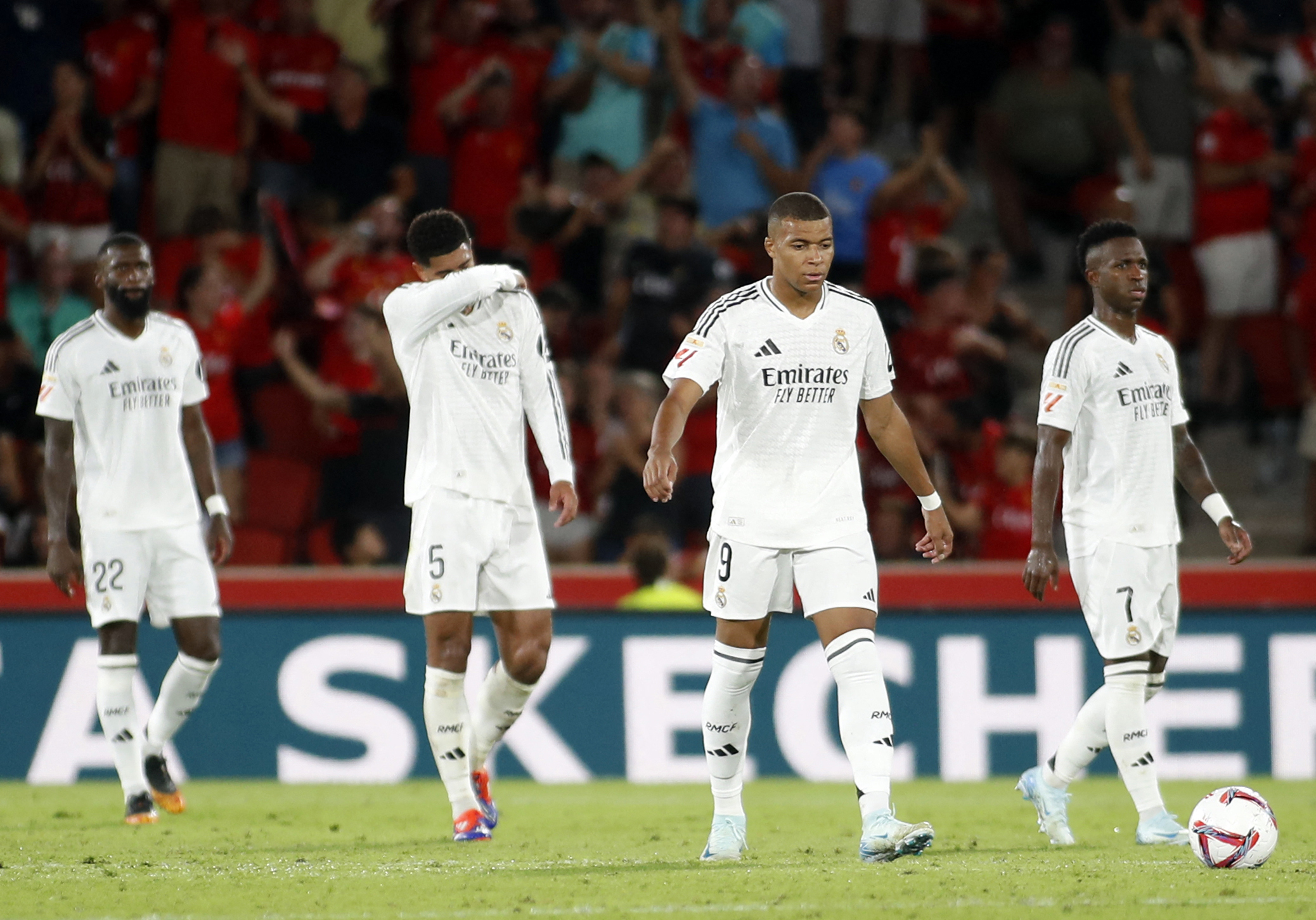 (From L) Real Madrid's German defender #22 Antonio Ruediger, Real Madrid's English midfielder #05 Jude Bellingham, Real Madrid's French forward #09 Kylian Mbappe and Real Madrid's Brazilian forward #07 Vinicius Junior react during the Spanish league football match between RCD Mallorca and Real Madrid CF at the Mallorca Son Moix stadium in Palma de Mallorca on August 18, 2024.