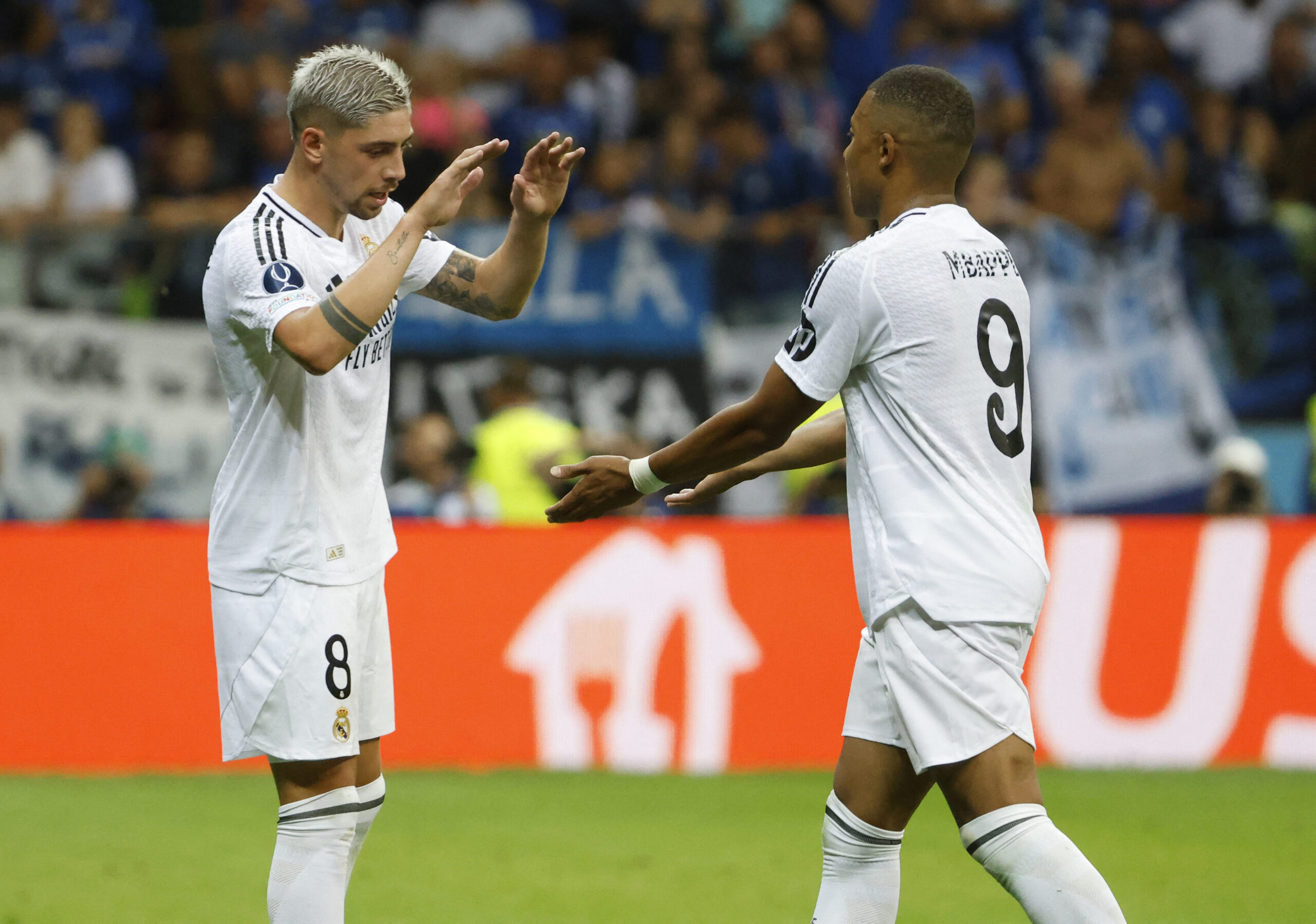 Real Madrid's Uruguayan midfielder #08 Federico Valverde celebrates with Real Madrid's French forward #09 Kylian Mbappe during the UEFA Super Cup football match between Real Madrid and Atalanta BC in Warsaw, on August 14, 2024.