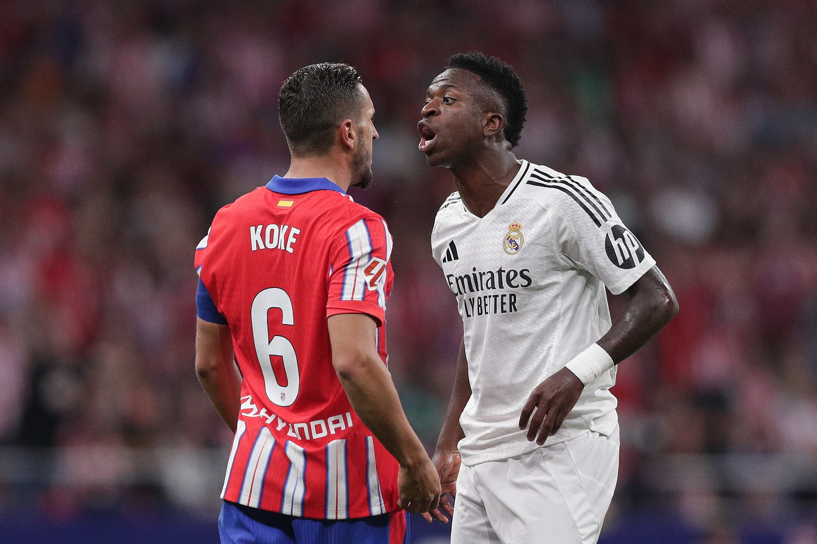 MADRID, SPAIN - SEPTEMBER 29: Vinicius Junior (R) of Real Madrid CF argues with Koke (L) of Atletico de Madrid during the LaLiga match between Atletico de Madrid and Real Madrid CF at Estadio Civitas Metropolitano on September 29, 2024 in Madrid, Spain.