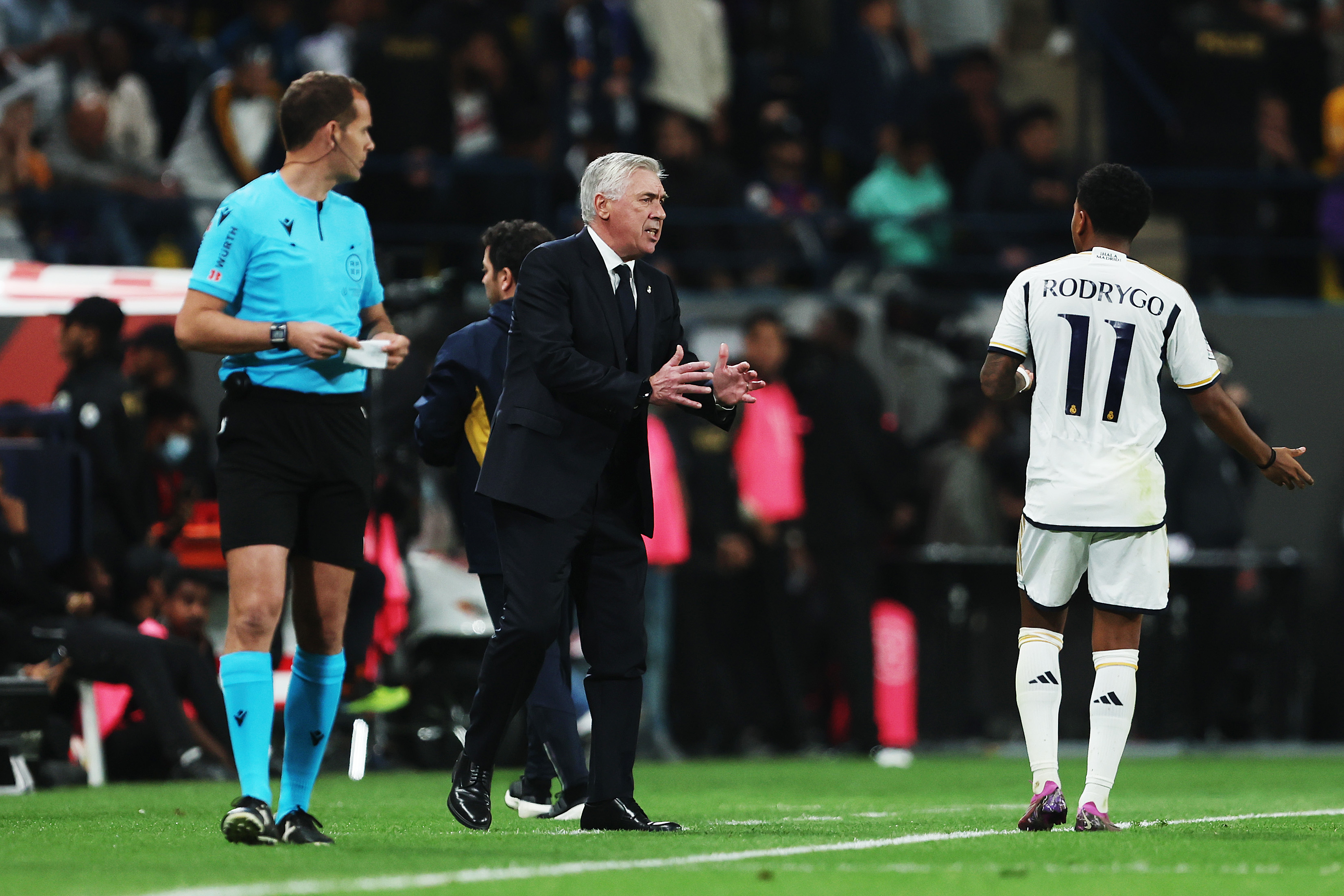 RIYADH, SAUDI ARABIA - JANUARY 14: Carlo Ancelotti, Head Coach of Real Madrid, speaks with Rodrygo of Real Madrid during the Super Copa de España Final match between Real Madrid and FC Barcelona on January 14, 2024 in Riyadh, Saudi Arabia.