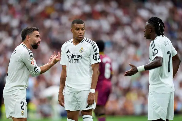 MADRID, SPAIN - AUGUST 25: Daniel Carvajal of Real Madrid interacts with his teammates Kylian Mbappe and Vinicius Junior during the La Liga match between Real Madrid CF and Real Valladolid CF at Estadio Santiago Bernabeu on August 25, 2024 in Madrid, Spain.