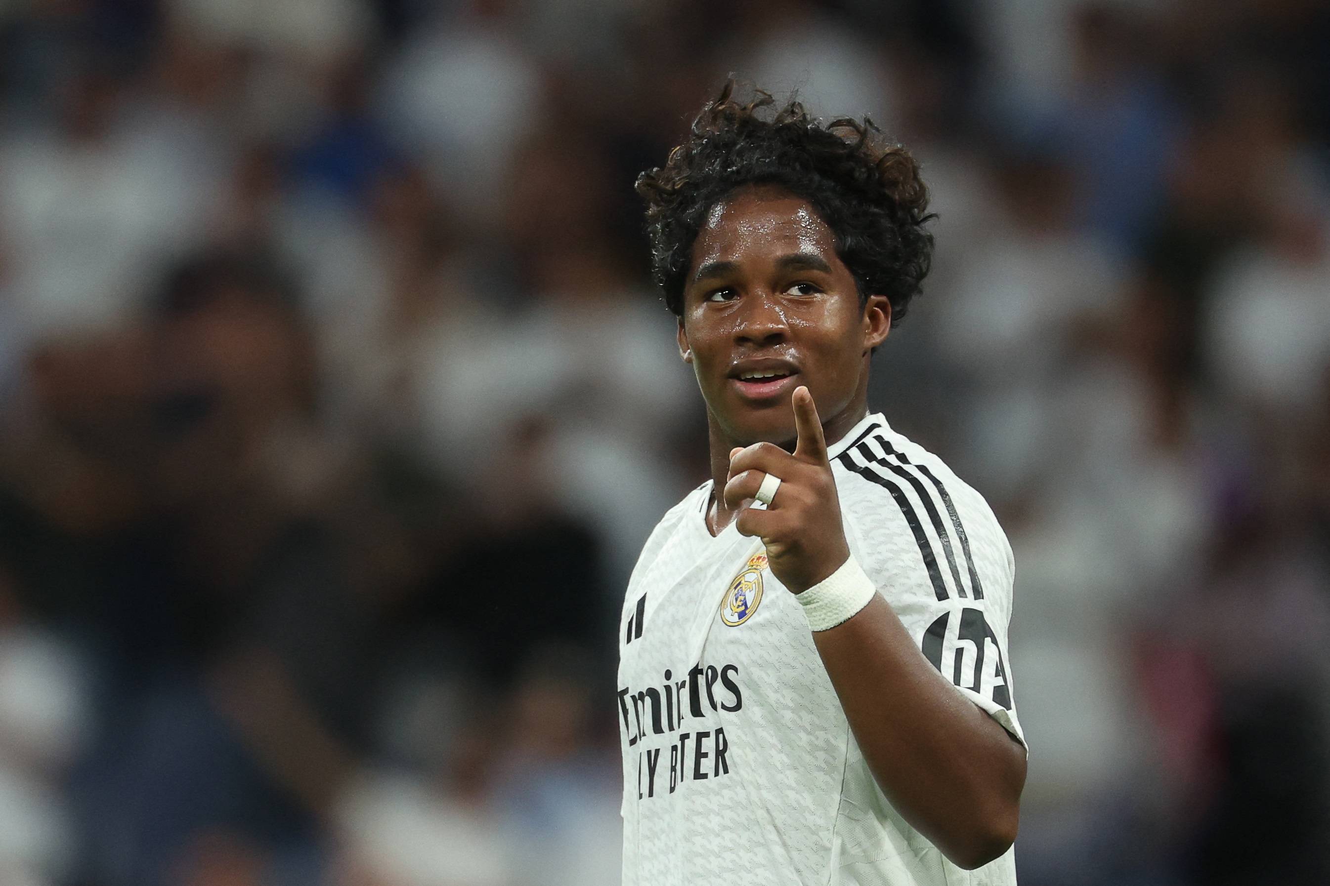 TOPSHOT - Real Madrid's Brazilian forward #16 Endrick celebrates after scoring his team's third goal during the UEFA Champions League 1st round day 1 football match between Real Madrid CF and Stuttgart VFB at the Santiago Bernabeu stadium in Madrid on September 17, 2024.