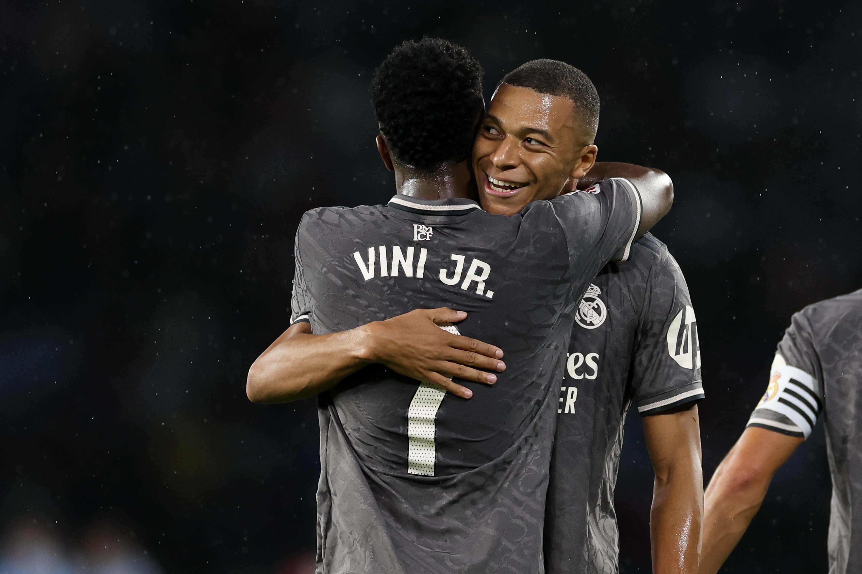 VIGO, SPAIN - OCTOBER 19: Kylian Mbappe of Real Madrid celebrates scoring his team's first goal with teammate Vinicius Junior during the LaLiga match between RC Celta de Vigo and Real Madrid CF at Estadio Balaidos on October 19, 2024 in Vigo, Spain.