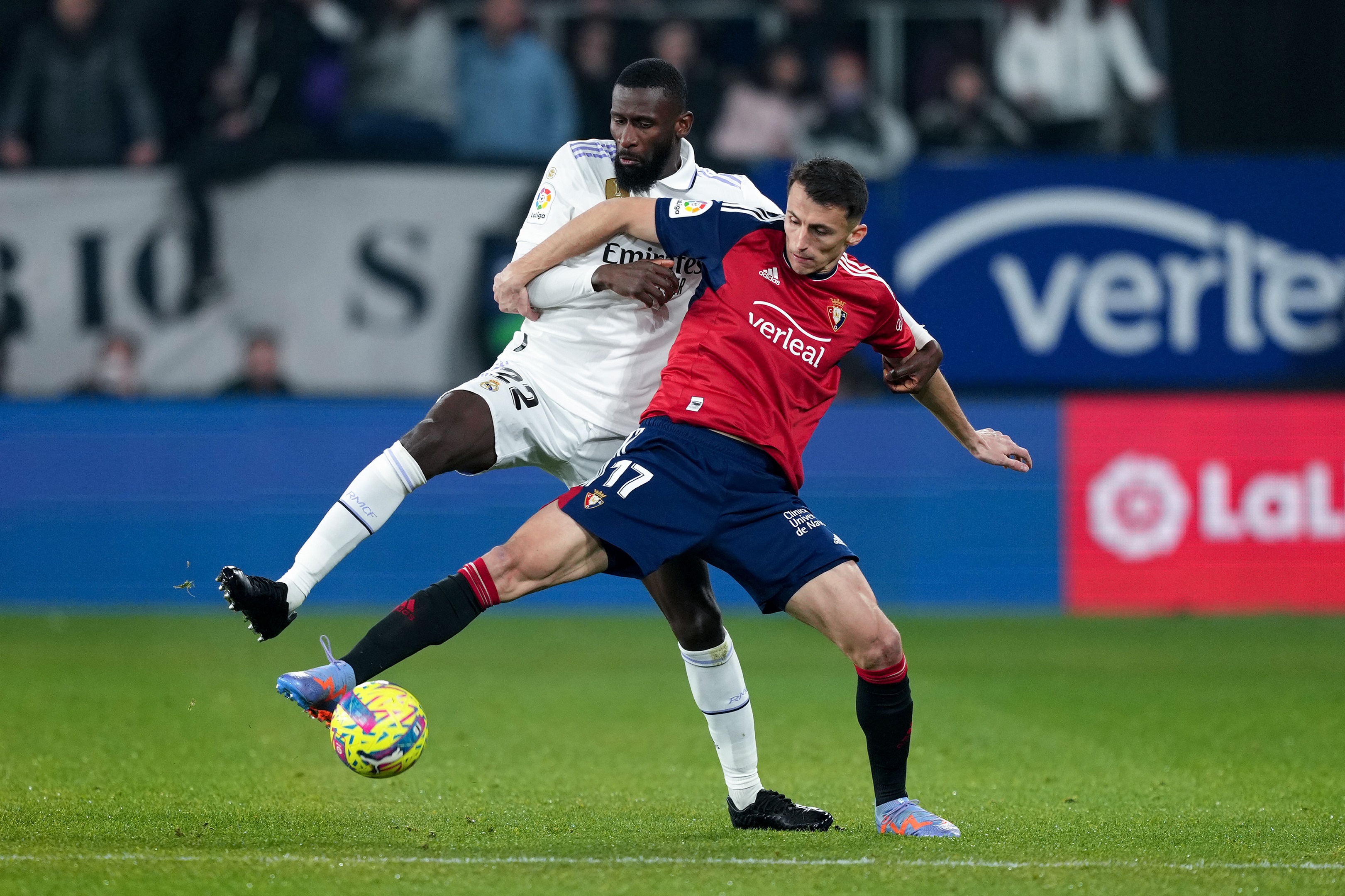PAMPLONA, SPAIN - FEBRUARY 18: Antonio Ruediger of Real Madrid challenges osa1 during the LaLiga Santander match between CA Osasuna and Real Madrid CF at El Sadar Stadium on February 18, 2023 in Pamplona, Spain.