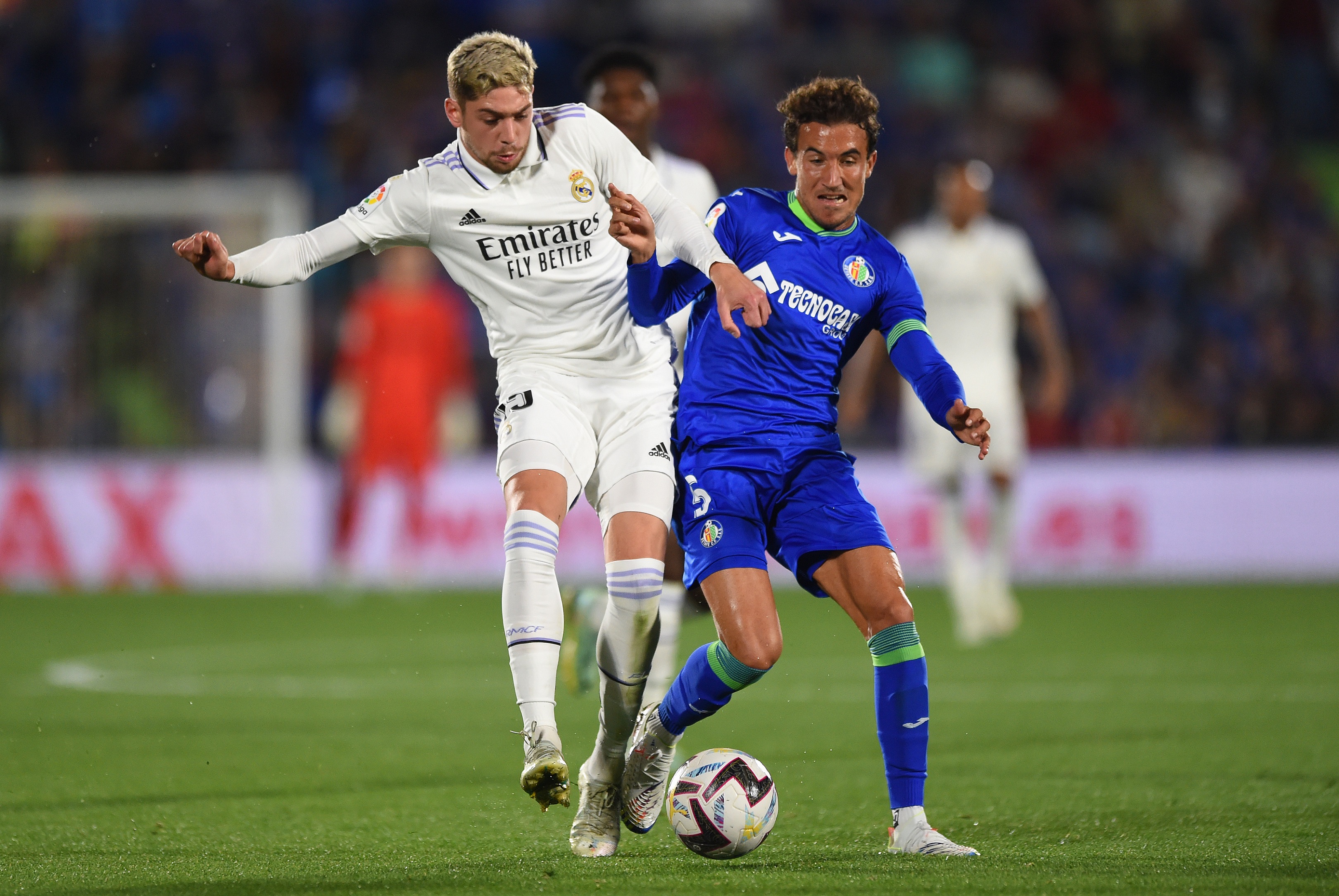 GETAFE, SPAIN - OCTOBER 08: Federico Valverde of Real Madrid battles for possession with Luis Milla of Getafe CF during the LaLiga Santander match between Getafe CF and Real Madrid CF at Coliseum Alfonso Perez on October 08, 2022 in Getafe, Spain.