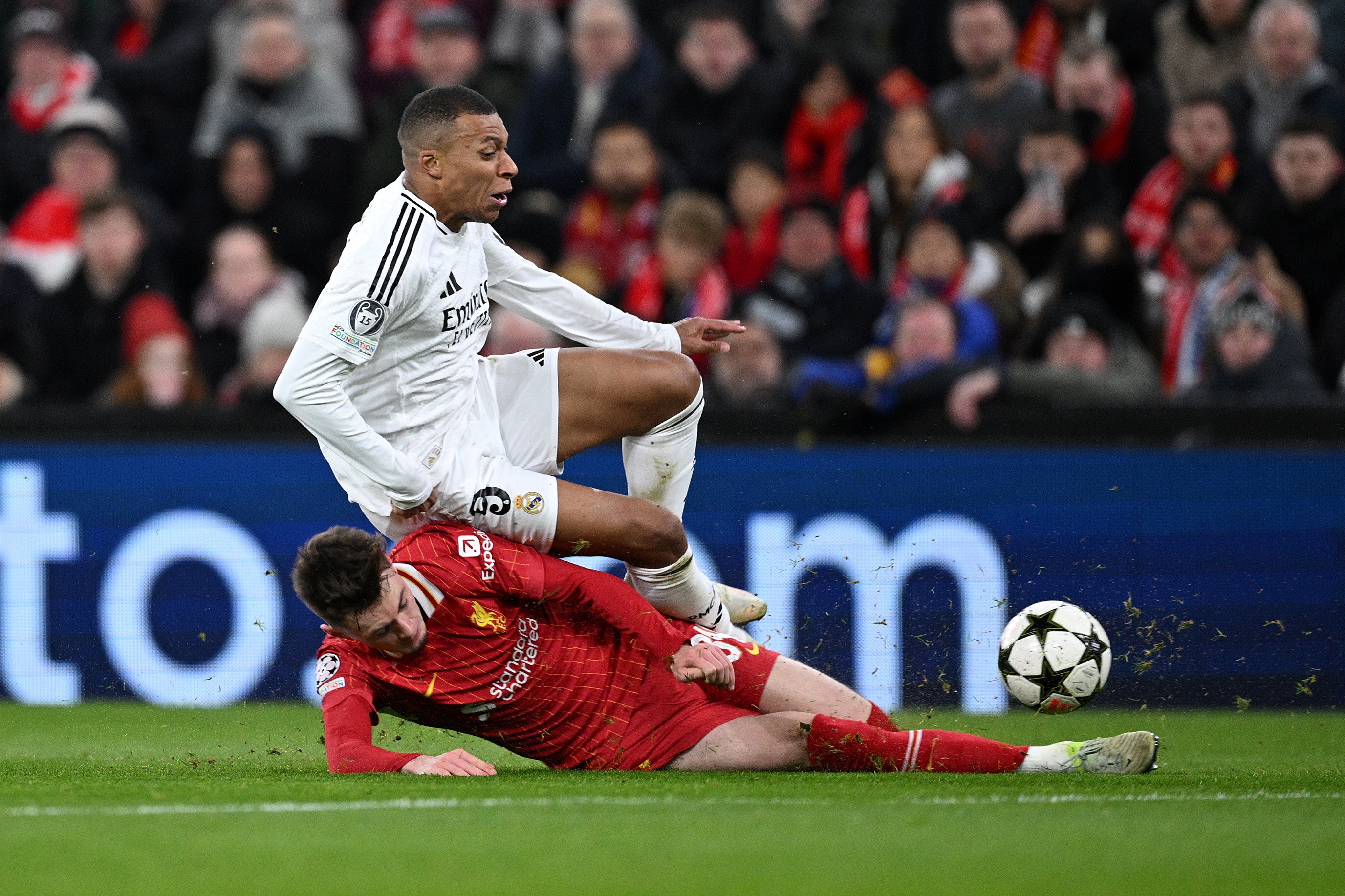 LIVERPOOL, ENGLAND - NOVEMBER 27: Kylian Mbappe of Real Madrid is challenged by Conor Bradley of Liverpool during the UEFA Champions League 2024/25 League Phase MD5 match between Liverpool FC and Real Madrid C.F. at Anfield on November 27, 2024 in Liverpool, England.
