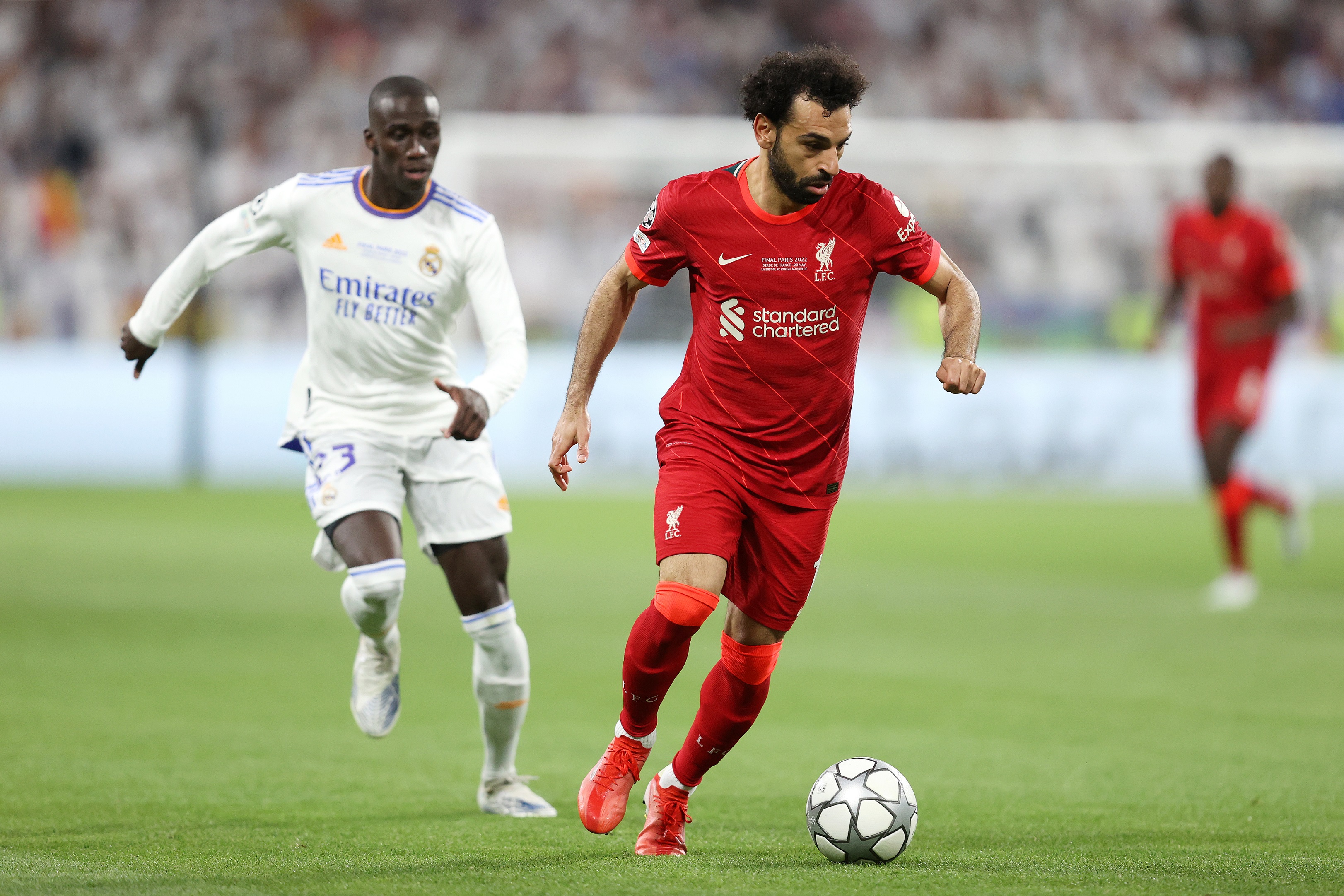 PARIS, FRANCE - MAY 28: Mohamed Salah of Liverpool runs with the ball from Ferland Mendy of Real Madrid during the UEFA Champions League final match between Liverpool FC and Real Madrid at Stade de France on May 28, 2022 in Paris, France.