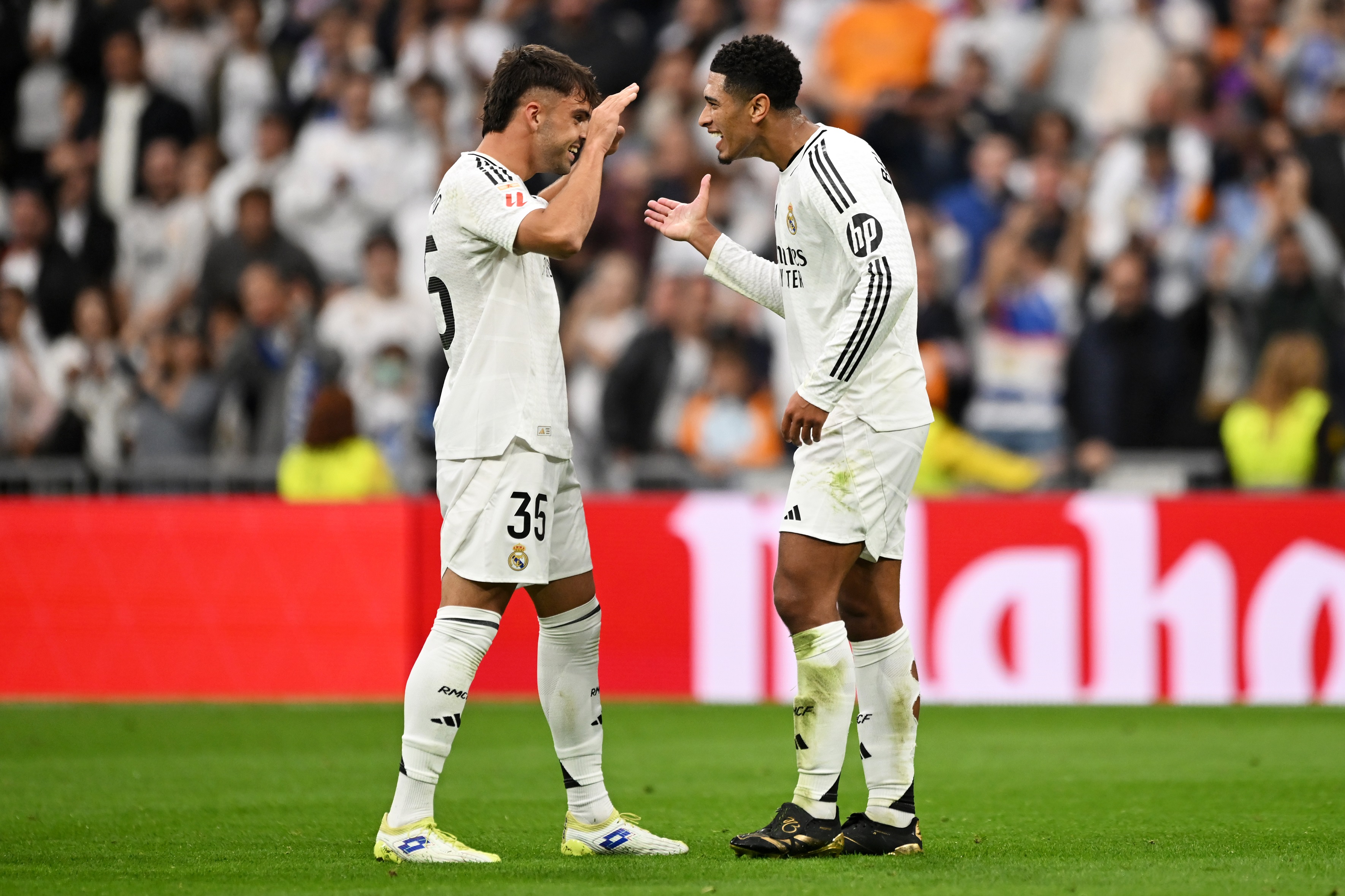 MADRID, SPAIN - NOVEMBER 09: Jude Bellingham of Real Madrid celebrates scoring his team's second goal with teammate Raul Asencio during the LaLiga match between Real Madrid CF and CA Osasuna at Estadio Santiago Bernabeu on November 09, 2024 in Madrid, Spain.