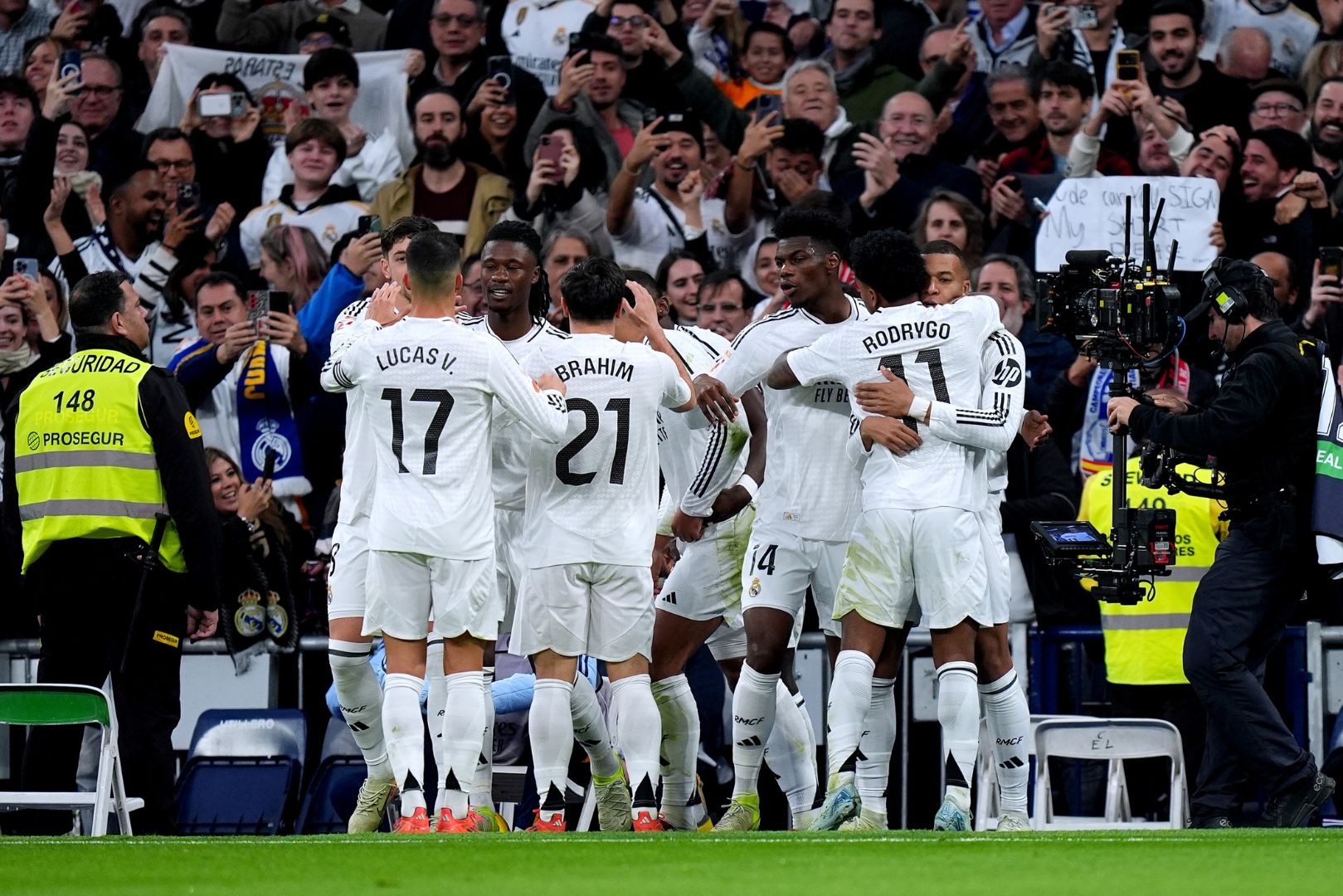 MADRID, SPAIN - DECEMBER 22: Kylian Mbappe of Real Madrid celebrates with teammates after scoring his sides first goal during the LaLiga match between Real Madrid CF and Sevilla FC at Estadio Santiago Bernabeu on December 22, 2024 in Madrid, Spain.