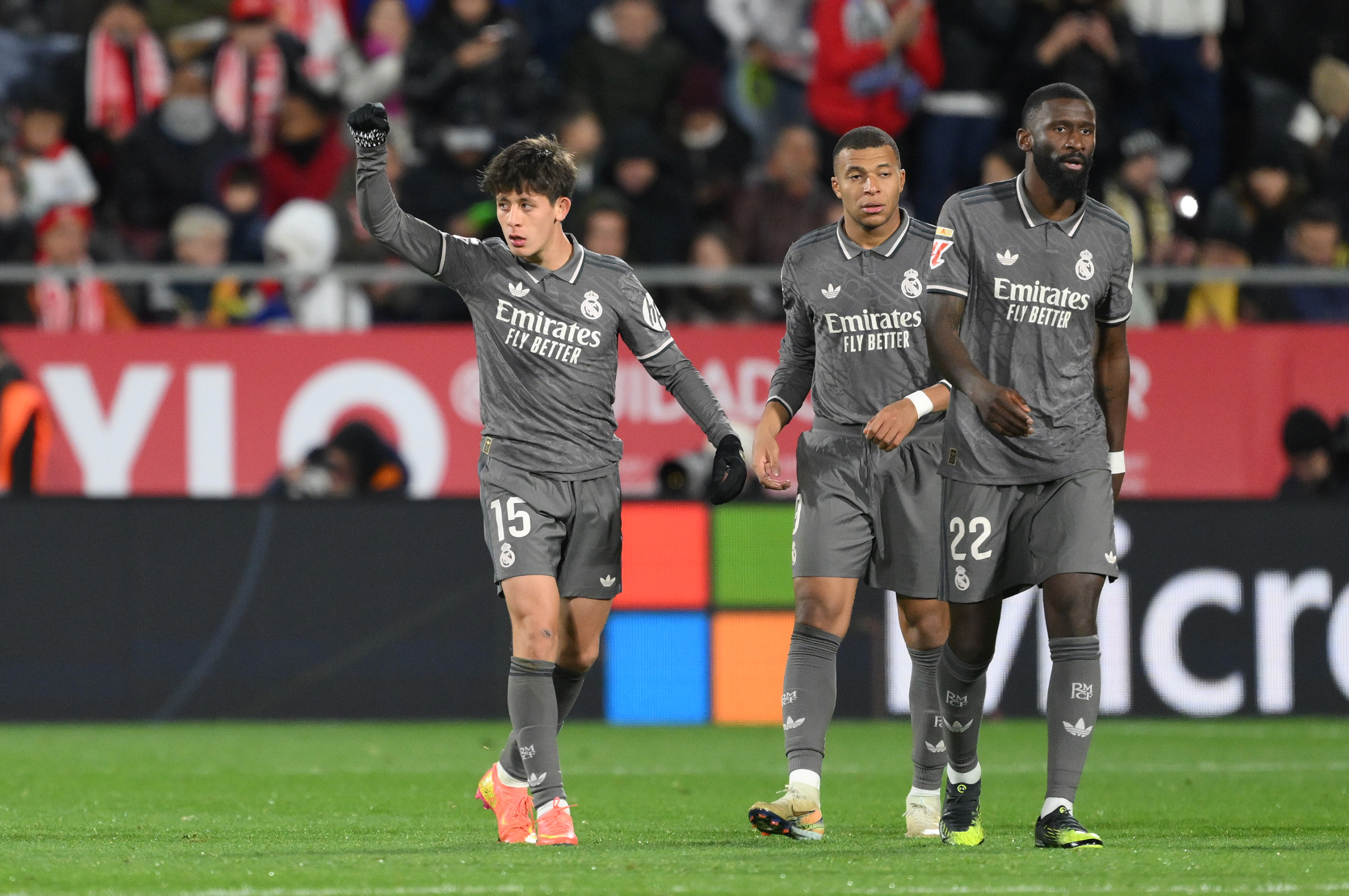 GIRONA, SPAIN - DECEMBER 07: Arda Gueler of Real Madrid celebrates scoring his team's second goal with teammates Kylian Mbappe and Antonio Ruediger during the LaLiga match between Girona FC and Real Madrid CF at Montilivi Stadium on December 07, 2024 in Girona, Spain.