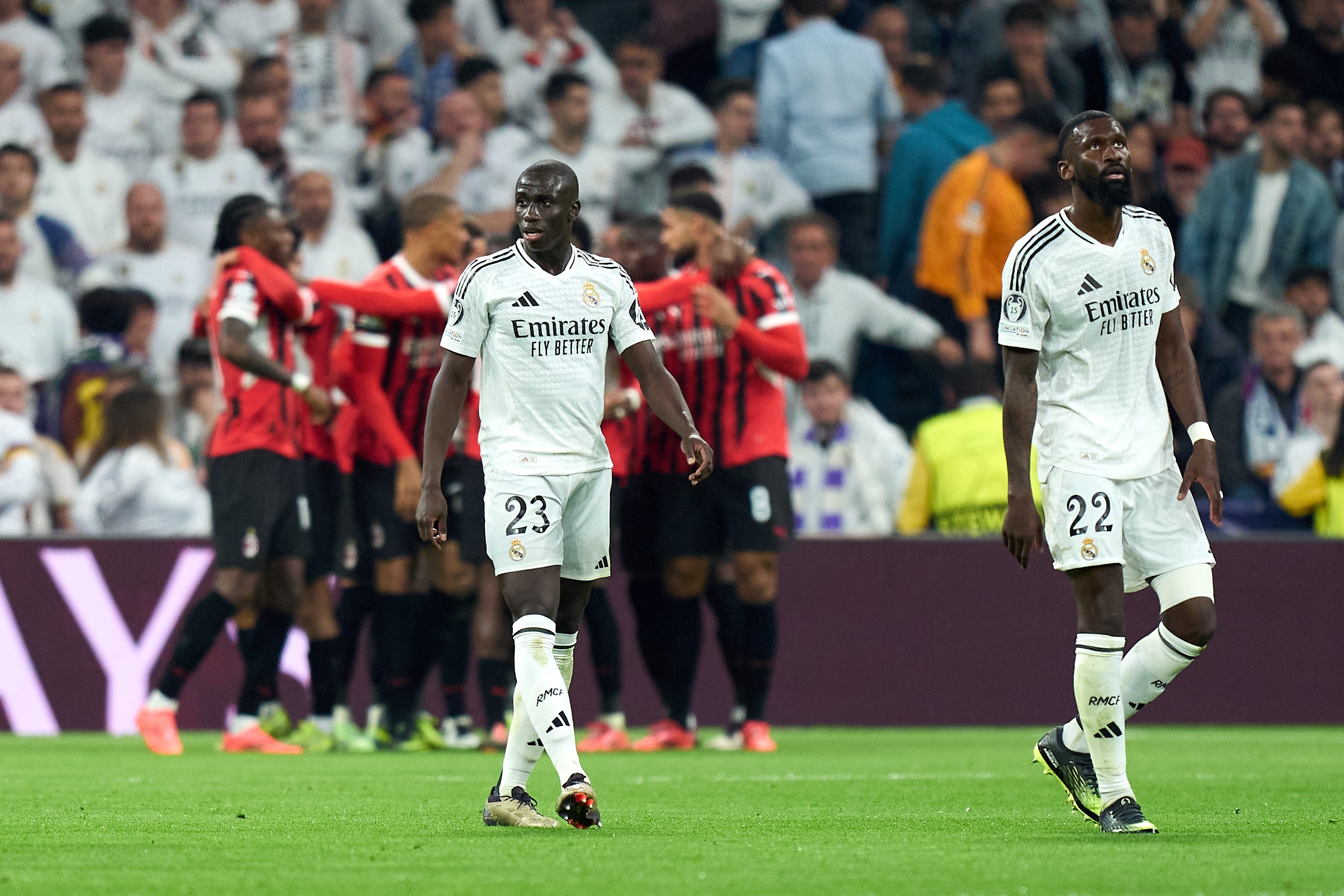 MADRID, SPAIN - NOVEMBER 05: Ferland Mendy and Antonio Rudiger of Real Madrid react after Tijjani Reijnders of AC Milan (not pictured) scores his team's third goal during the UEFA Champions League 2024/25 League Phase MD4 match between Real Madrid C.F. and AC Milan at Estadio Santiago Bernabeu on November 05, 2024 in Madrid, Spain.