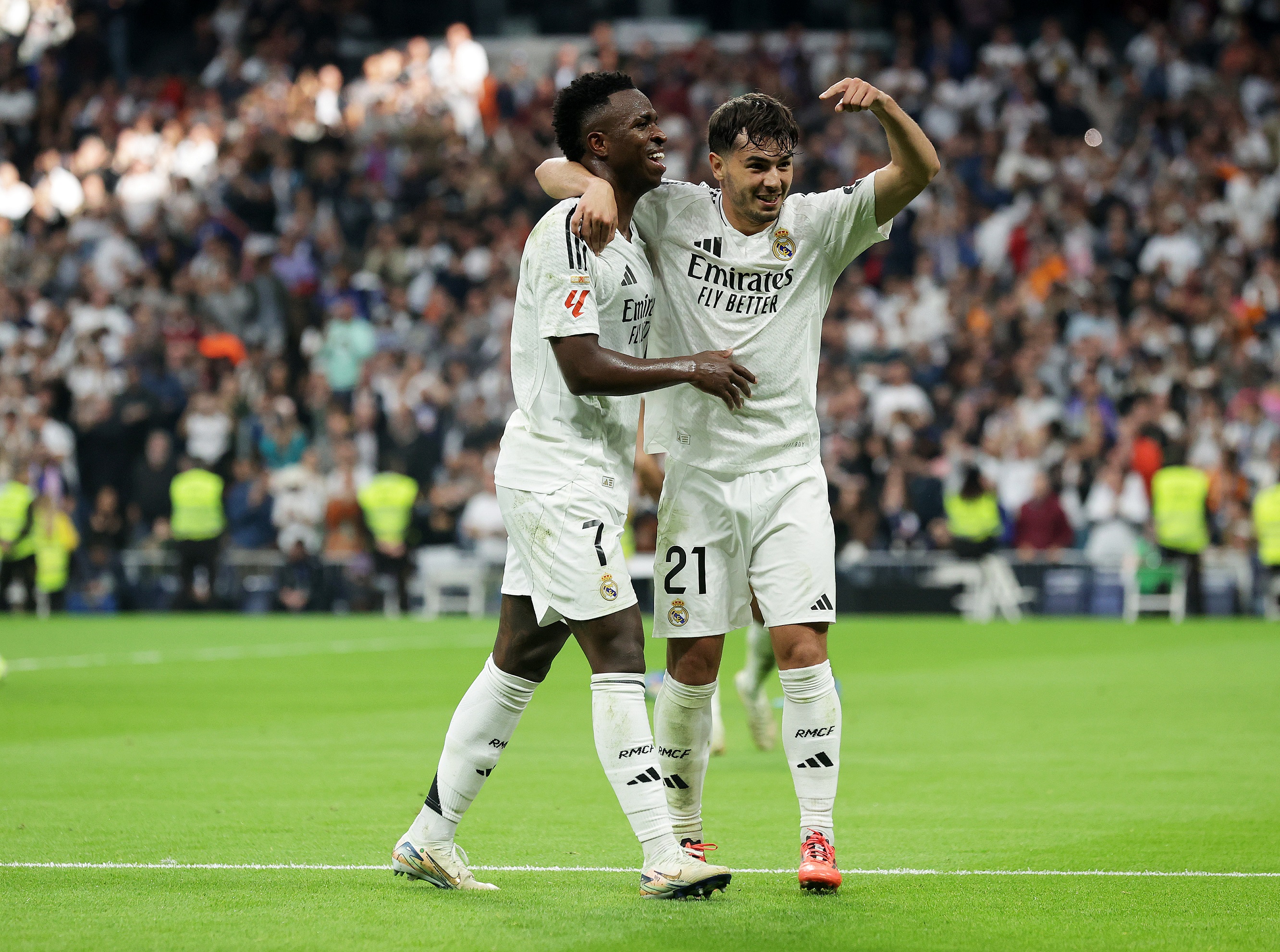 MADRID, SPAIN - NOVEMBER 09: Vinicius Junior of Real Madrid scores his team's third goal with teammate Brahim Diaz during the LaLiga match between Real Madrid CF and CA Osasuna at Estadio Santiago Bernabeu on November 09, 2024 in Madrid, Spain.