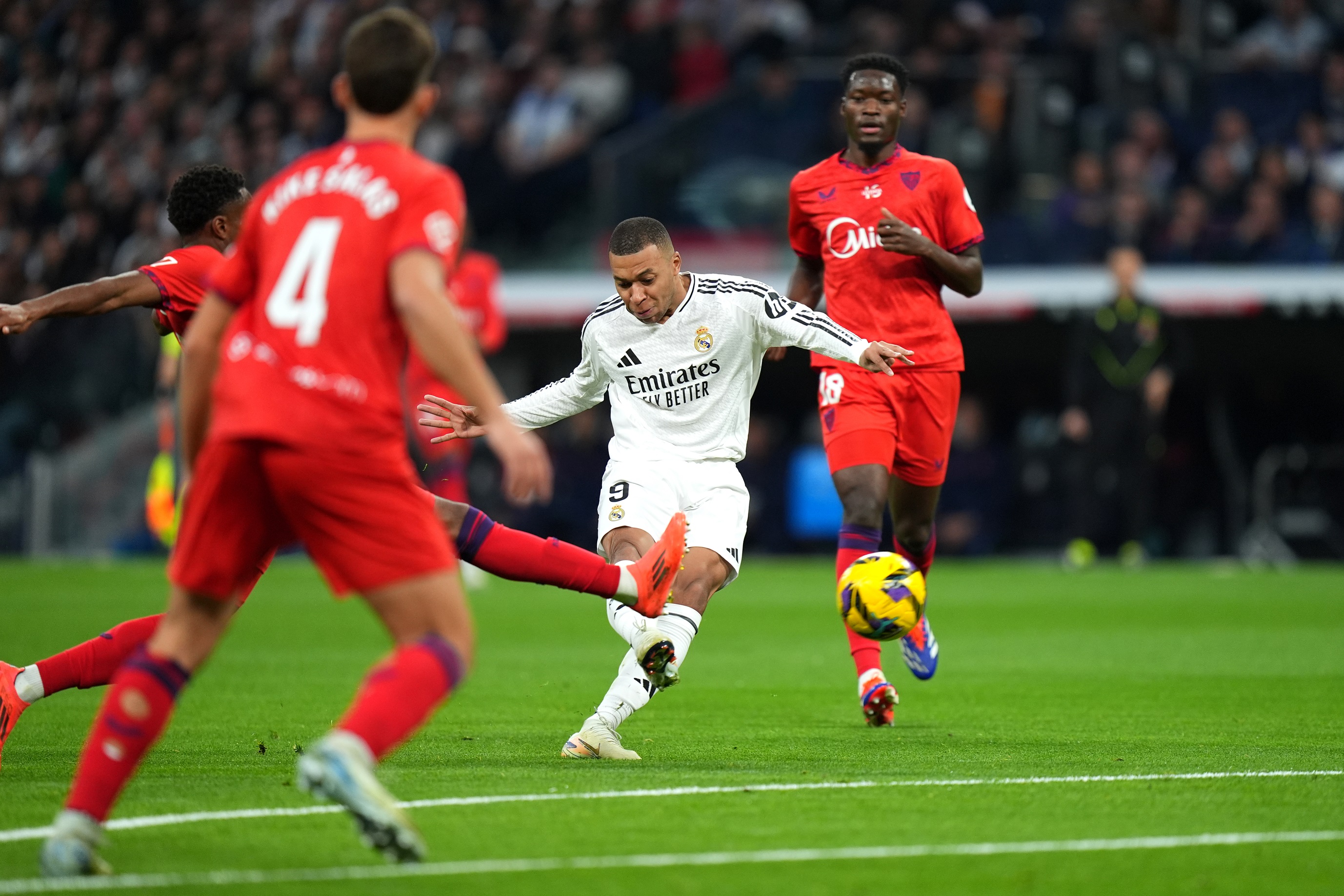 MADRID, SPAIN - DECEMBER 22: Kylian Mbappe of Real Madrid scores his team's first goal during the LaLiga match between Real Madrid CF and Sevilla FC at Estadio Santiago Bernabeu on December 22, 2024 in Madrid, Spain.