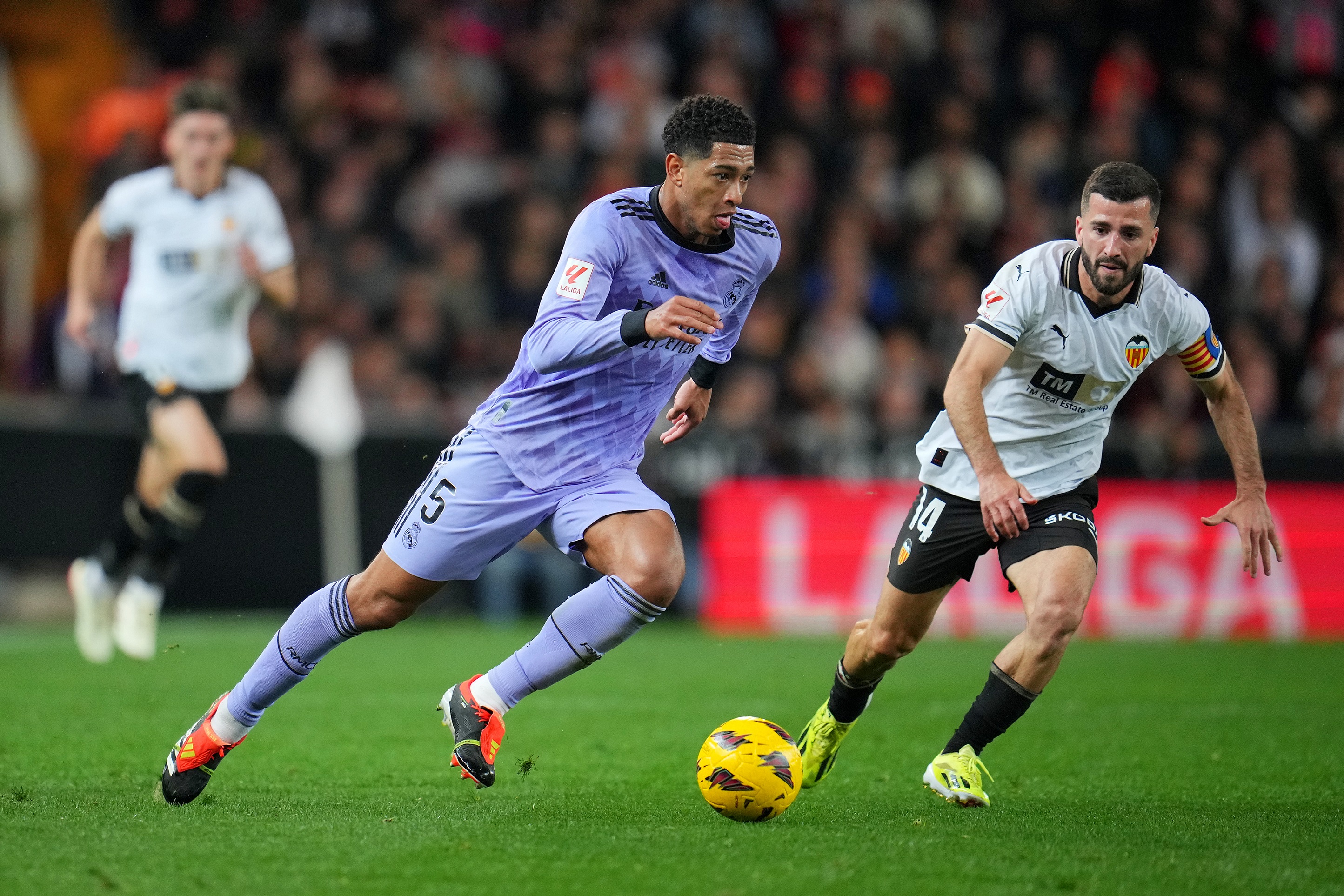 VALENCIA, SPAIN - MARCH 02: Jude Bellingham of Real Madrid runs with the ball under pressure from Jose Luis Gaya of Valencia CF during the LaLiga EA Sports match between Valencia CF and Real Madrid CF at Estadio Mestalla on March 02, 2024 in Valencia, Spain.