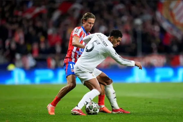 MADRID, SPAIN - MARCH 12: Jude Bellingham of Real Madrid is challenged by Marcos Llorente of Atletico de Madrid during the UEFA Champions League 2024/25 Round of 16 second leg match between Atletico de Madrid and Real Madrid C.F. at Estadio Metropolitano on March 12, 2025 in Madrid, Spain.