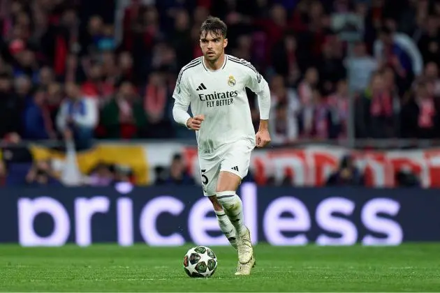 MADRID, SPAIN - MARCH 12: Raul Asencio of Real Madrid runs with the ball during the UEFA Champions League 2024/25 UEFA Champions League 2024/25 Round of 16 second leg match between Atletico de Madrid and Real Madrid C.F. at Riyadh Air Metropolitano on March 12, 2025 in Madrid, Spain.