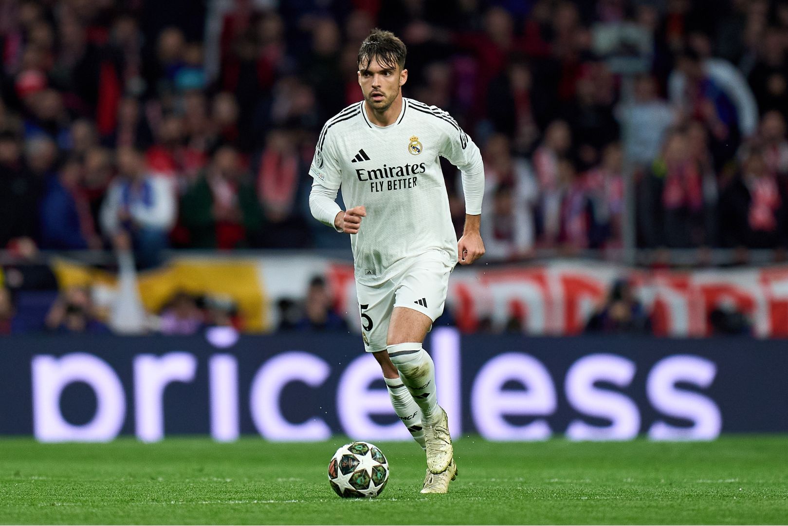 MADRID, SPAIN - MARCH 12: Raul Asencio of Real Madrid runs with the ball during the UEFA Champions League 2024/25 UEFA Champions League 2024/25 Round of 16 second leg match between Atletico de Madrid and Real Madrid C.F. at Riyadh Air Metropolitano on March 12, 2025 in Madrid, Spain.