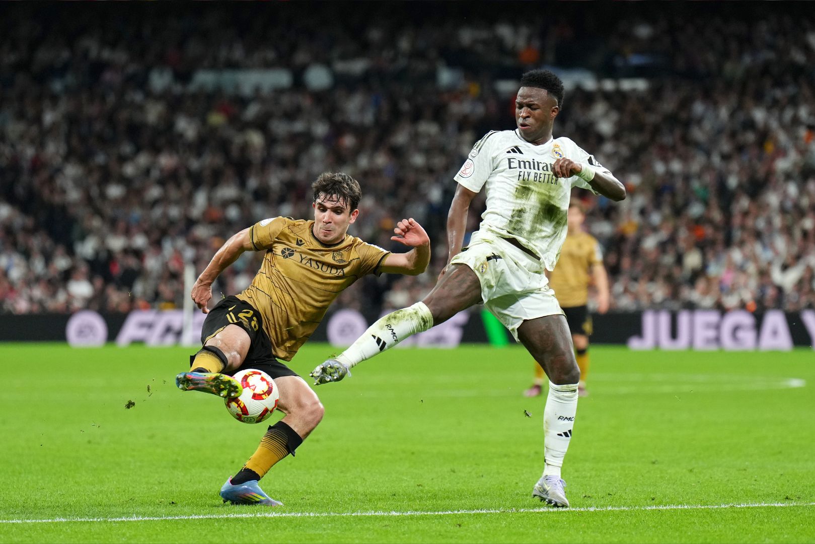 MADRID, SPAIN - APRIL 01: Pablo Marin Real Sociedad battles for the ball with Vinicius Junior of Real Madrid during the Copa del Rey semifinal match between Real Madrid and Real Sociedad at Estadio Santiago Bernabeu on April 01, 2025 in Madrid, Spain.