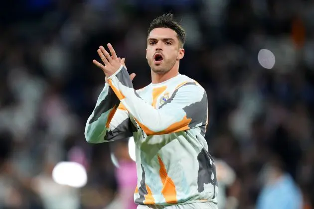 MADRID, SPAIN - APRIL 16: Raul Asencio of Real Madrid applauds the fans as he warms up prior to the UEFA Champions League 2024/25 Quarter Final Second Leg match between Real Madrid C.F. and Arsenal FC at Estadio Santiago Bernabeu on April 16, 2025 in Madrid, Spain.