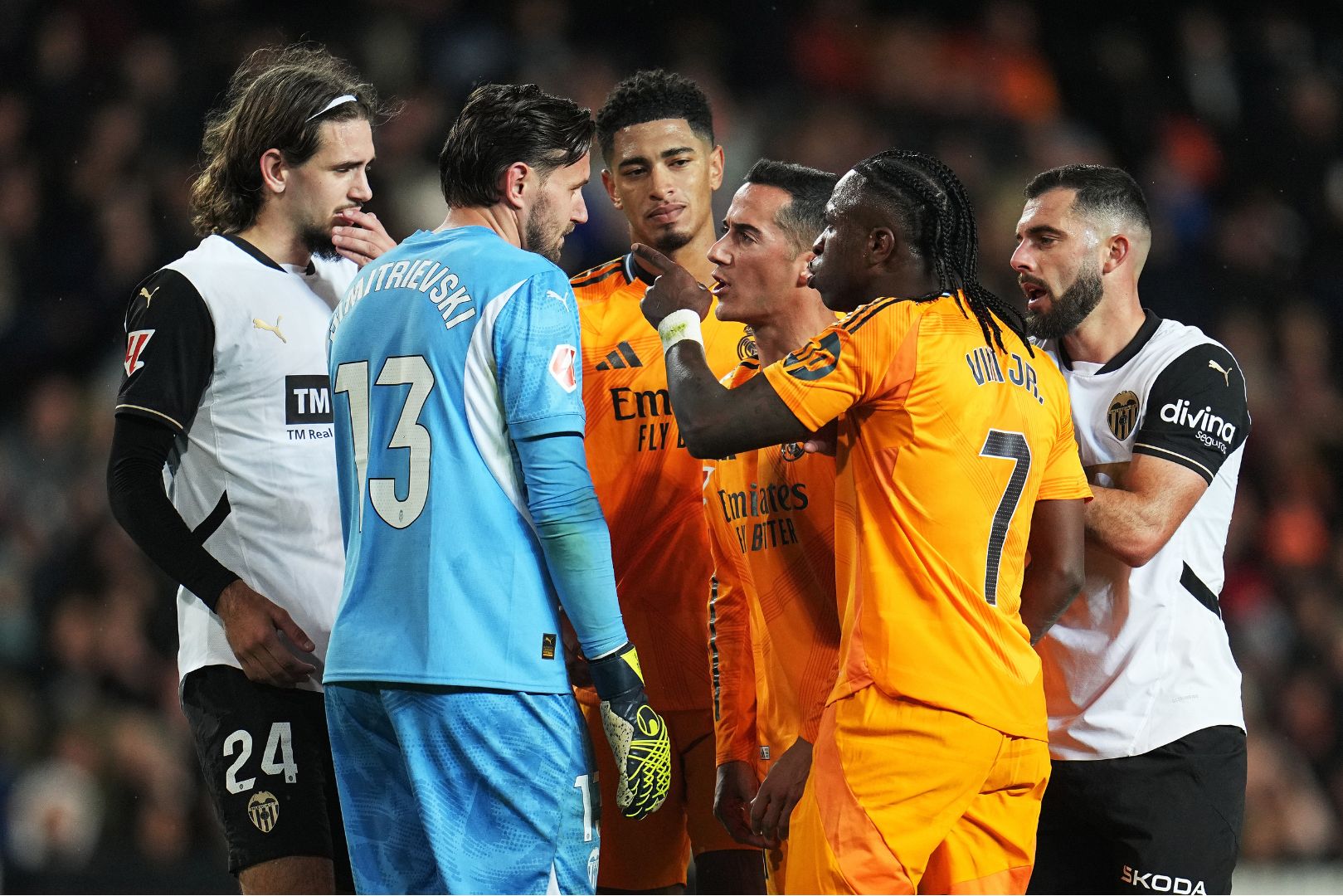 VALENCIA, SPAIN - JANUARY 03: Vinicius Junior of Real Madrid reacts towards Stole Dimitrievski of Valencia CF after an earlier incident between them and is later shown a red card during the LaLiga match between Valencia CF and Real Madrid CF at Estadio Mestalla on January 03, 2025 in Valencia, Spain.